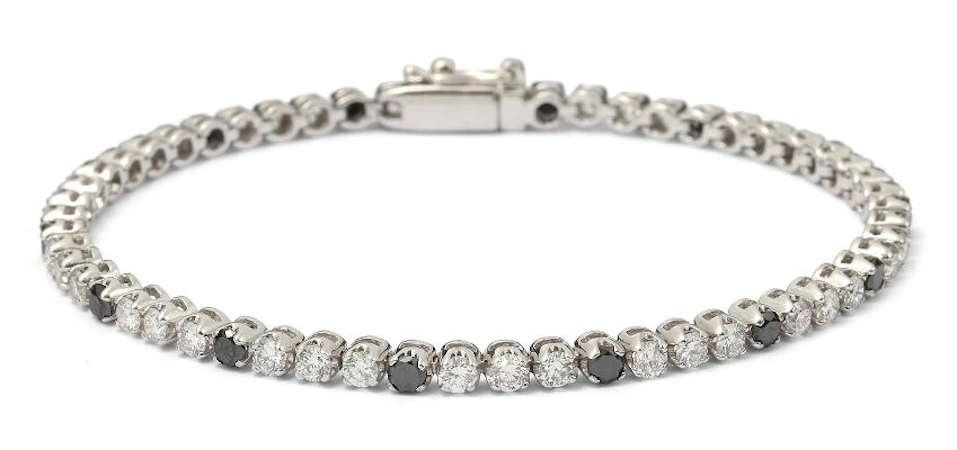 A diamond bracelet set with numerous black and white diamonds mounted