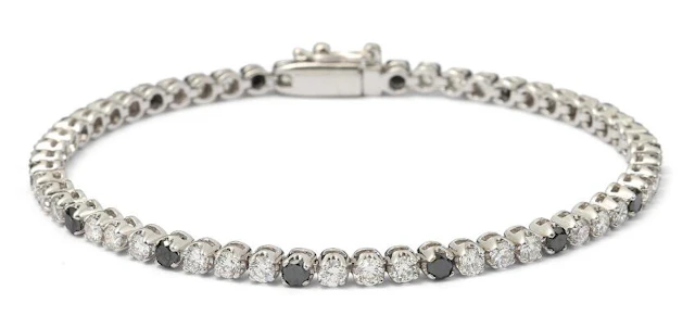 A diamond bracelet set with numerous black and white diamonds mounted