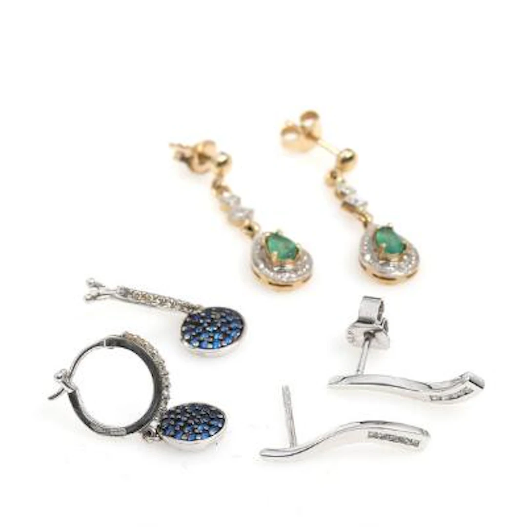 Three pairs of earrings respectivly of 9k and 18k gold and white gold.
