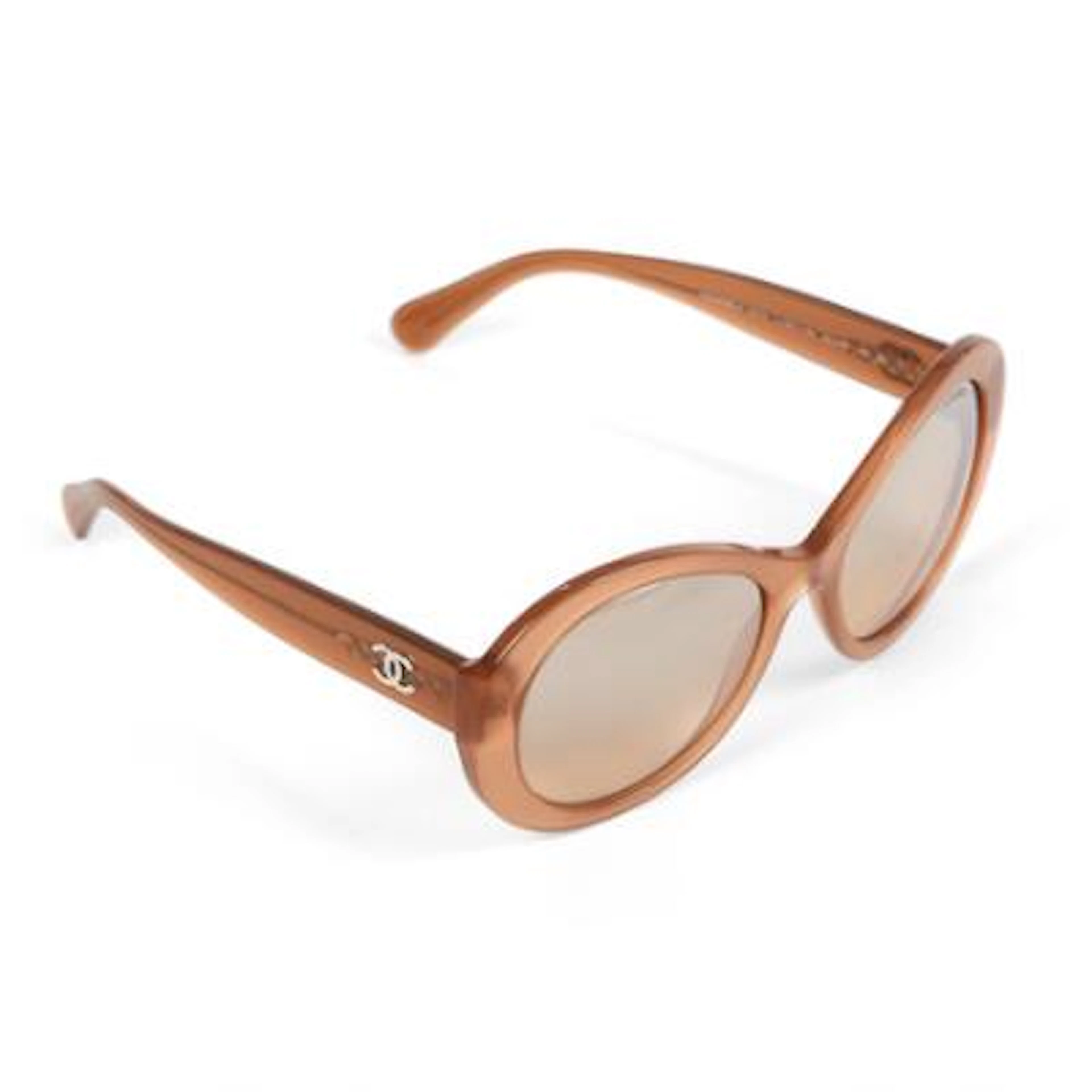 Chanel: A pair of sunglasses with brown frames and dark glass. Model
