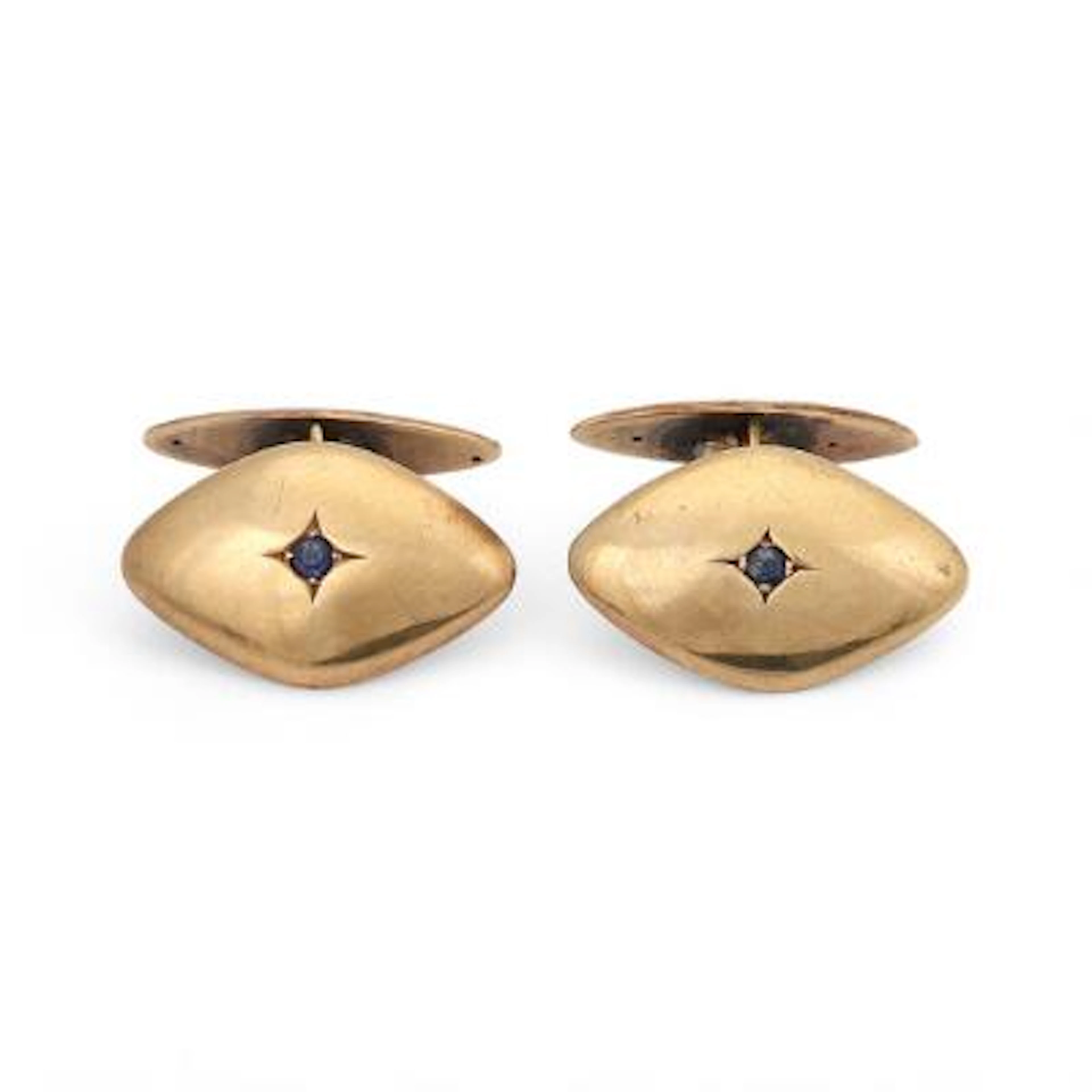 A pair of cufflinks set with a circular-cut syntetic sapphire, mounted