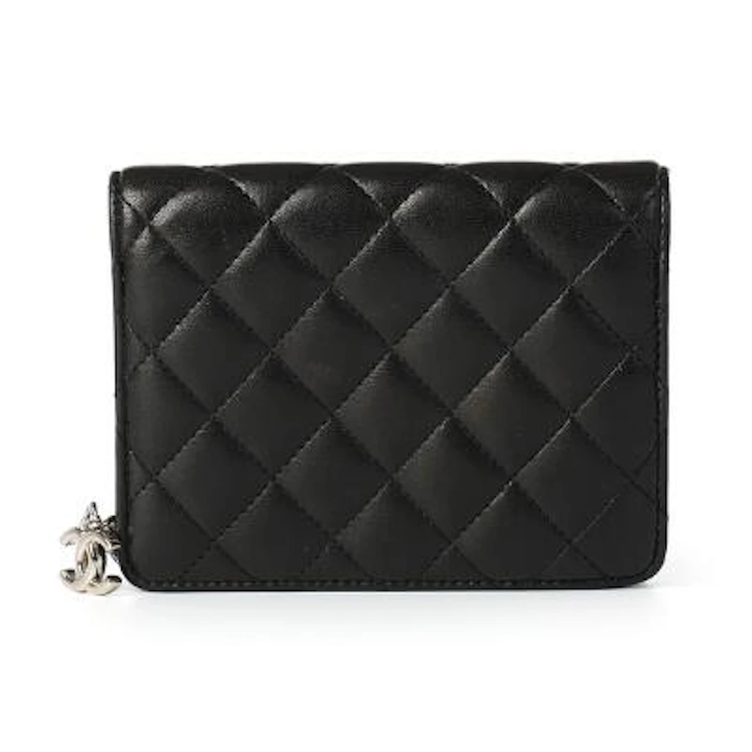 Chanel: A wallet of black quilted leather with silver-toned hardware