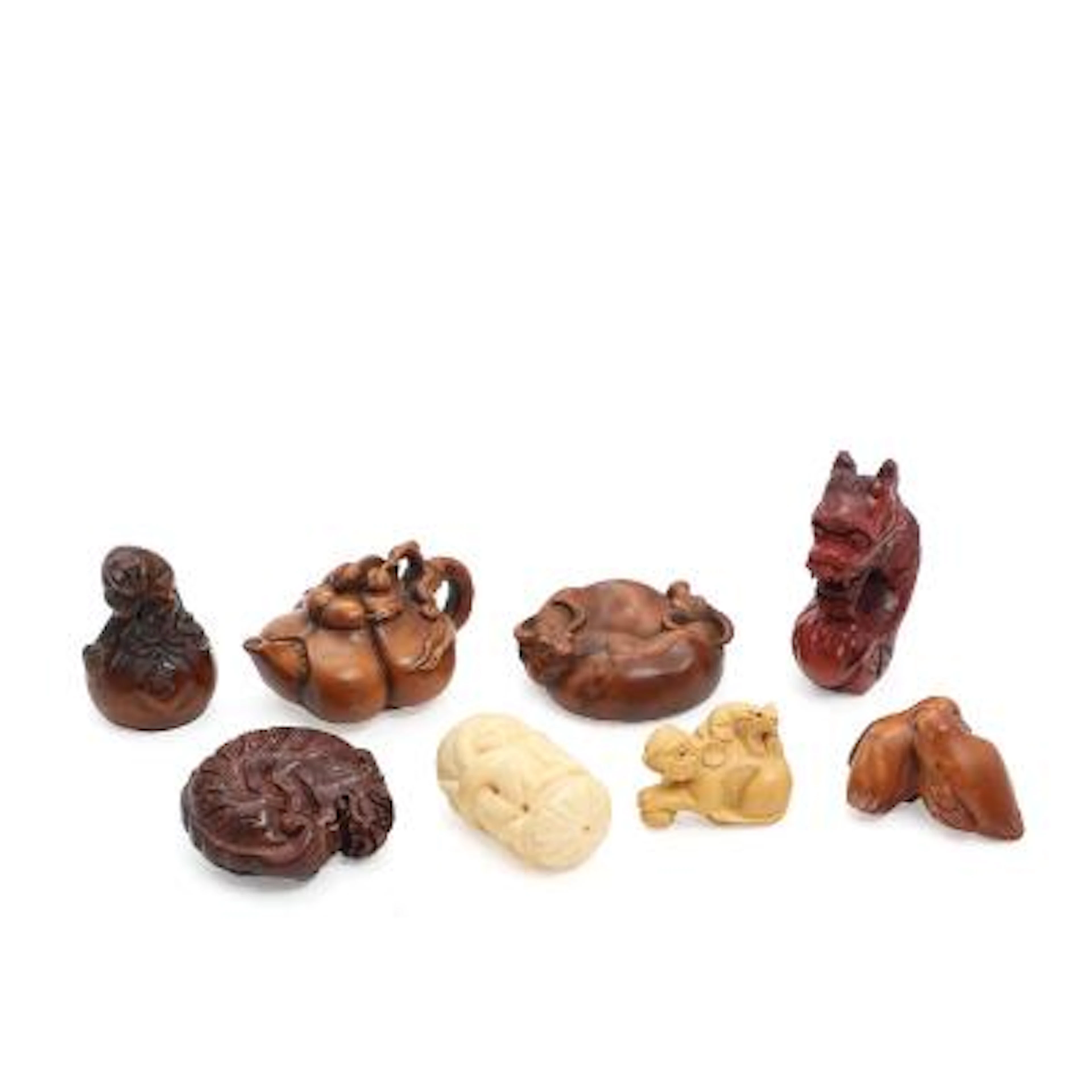 Eight netsuke of carved wood and bone. Several signed. 20th century.