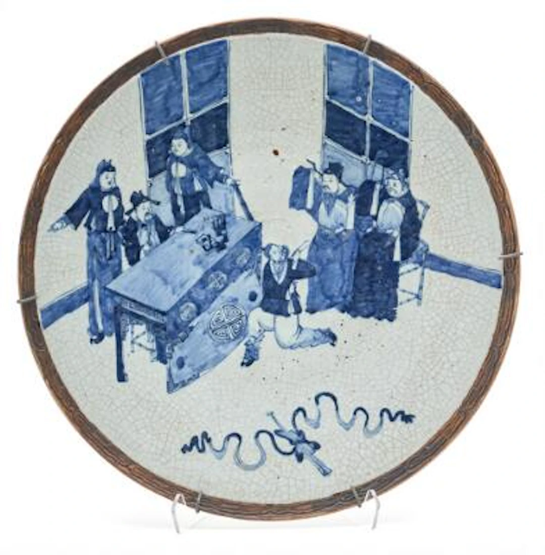 A Chinese charger of porcelain, decorated in blue on crackle ground.