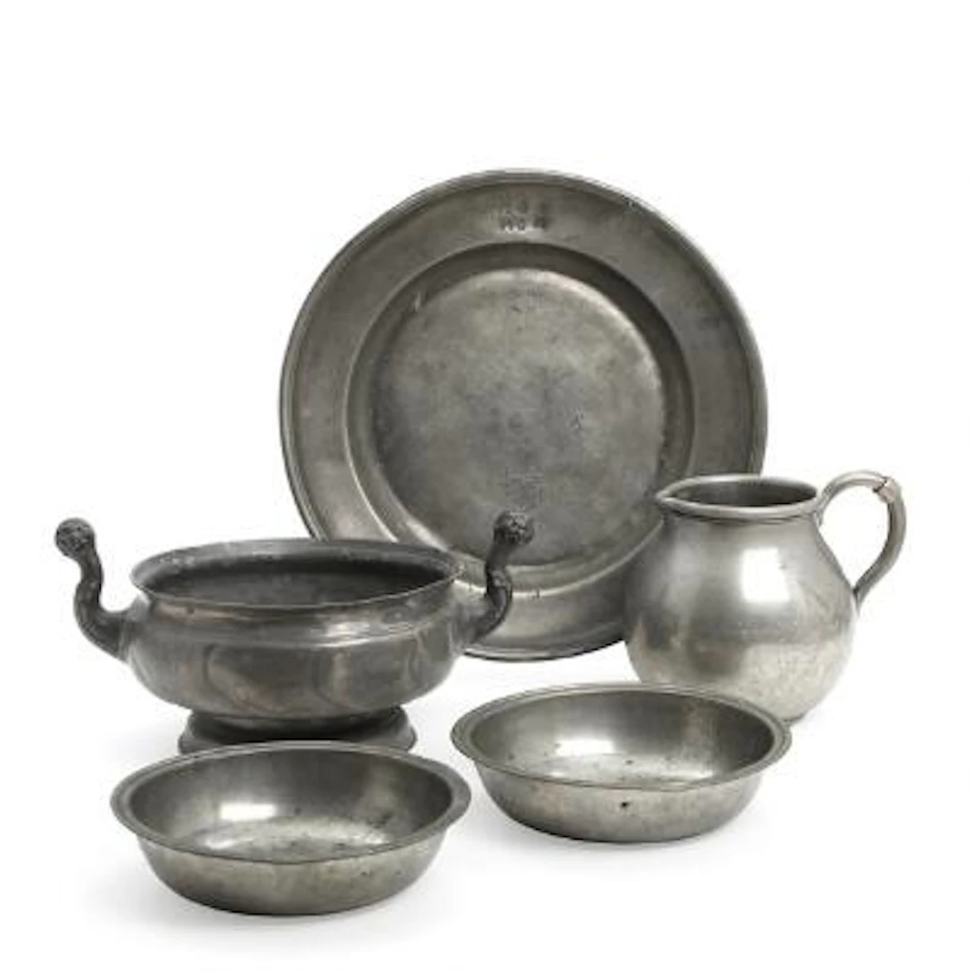 A collection of pewter, consisting of a jug, two bowls, a round dish