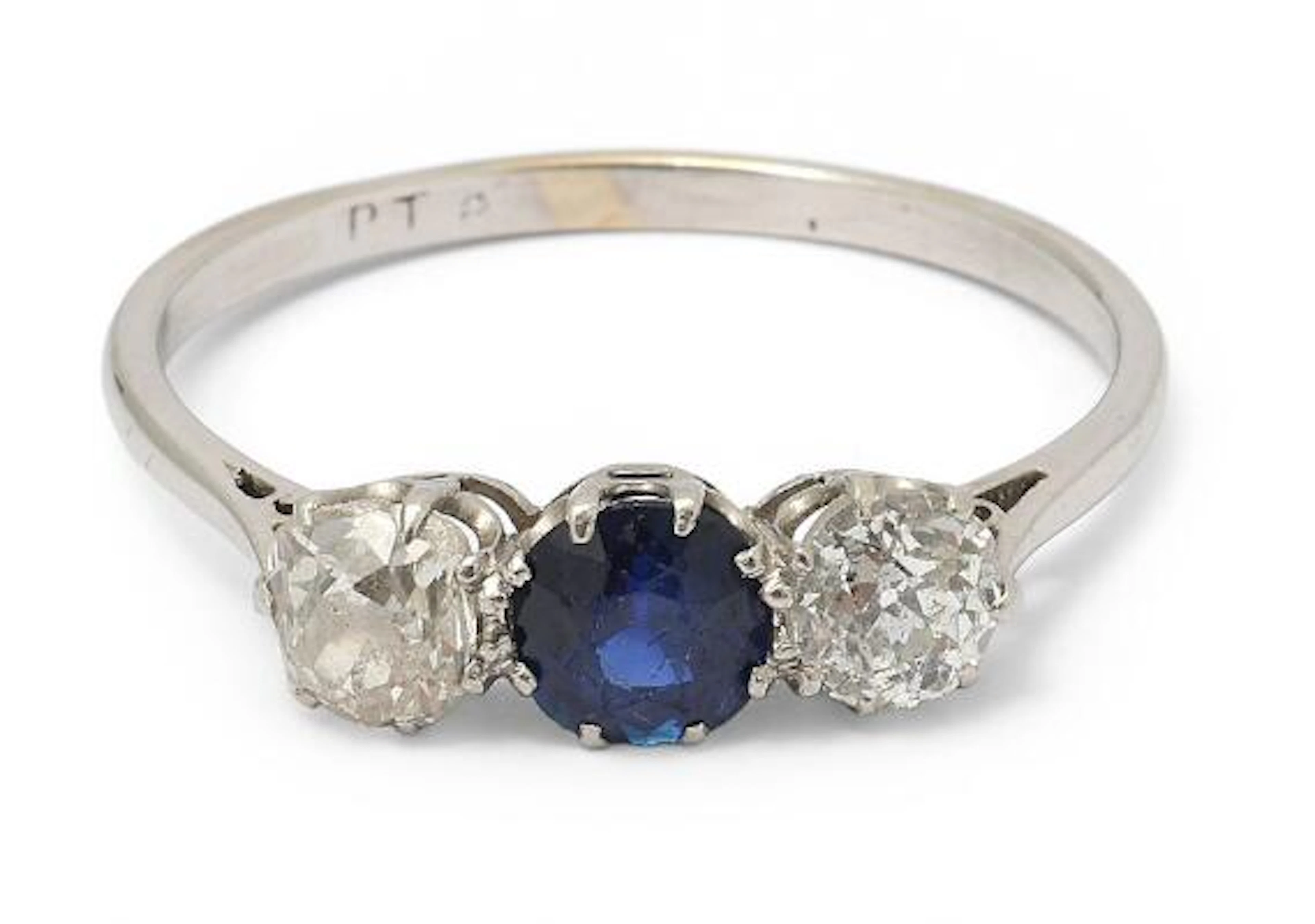 A sapphire and diamond ring set with a sapphire and two diamonds