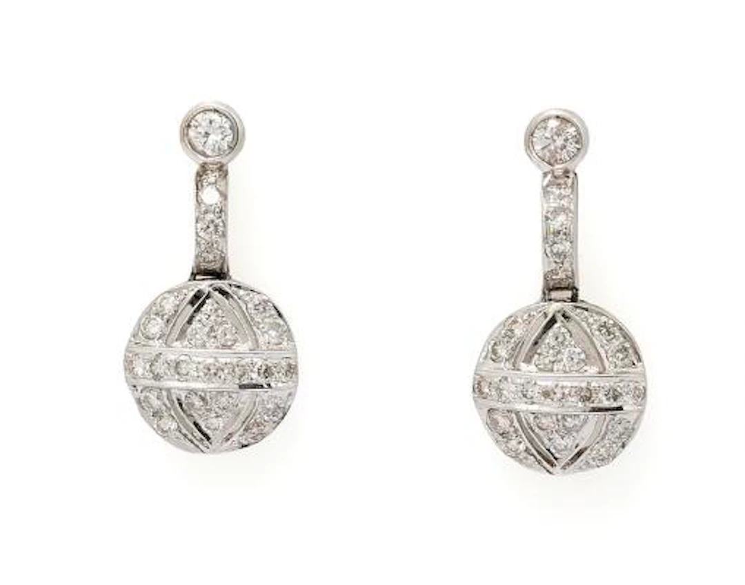 A pair of diamond ear pendants set with numerous diamonds mounted