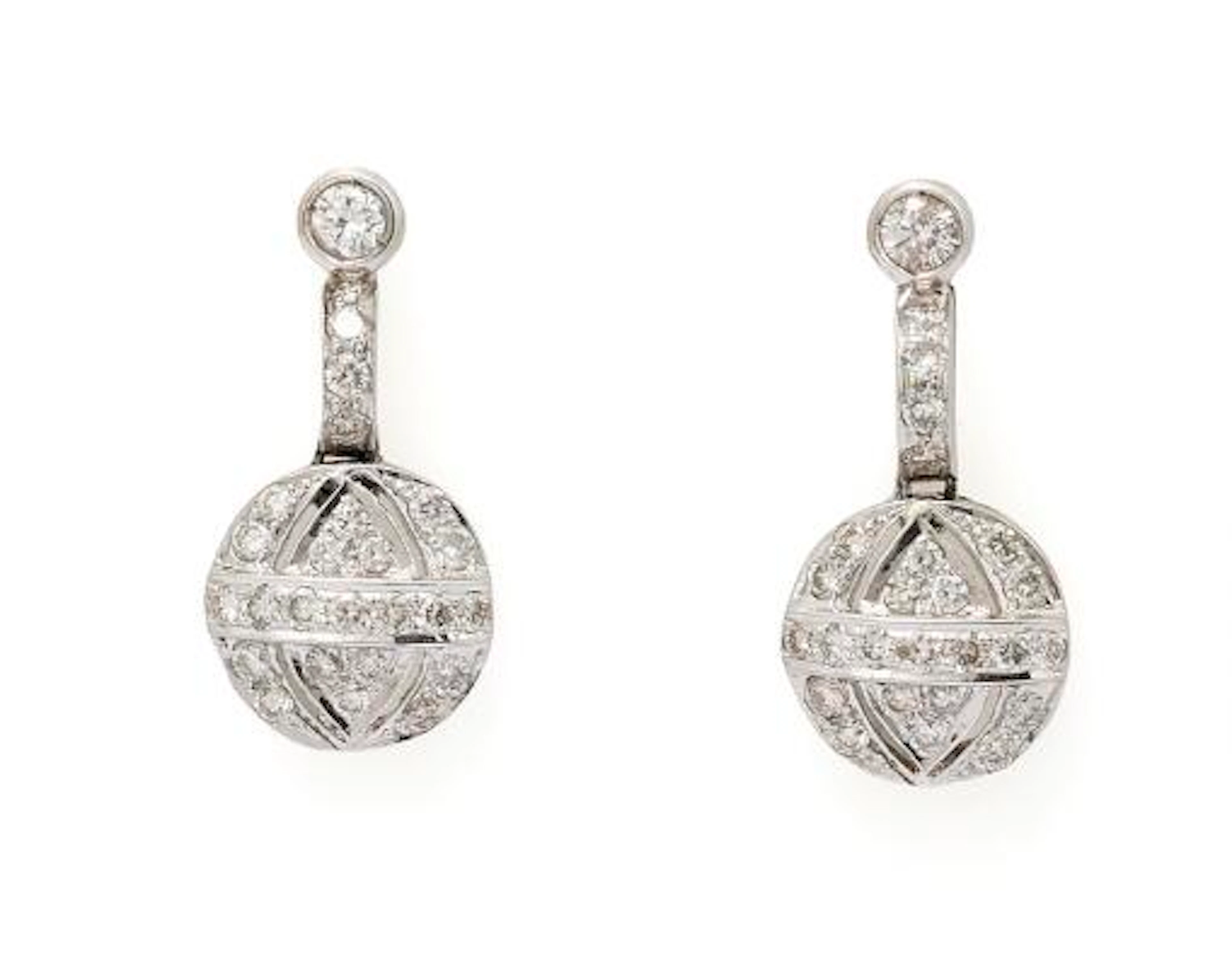 A pair of diamond ear pendants set with numerous diamonds mounted