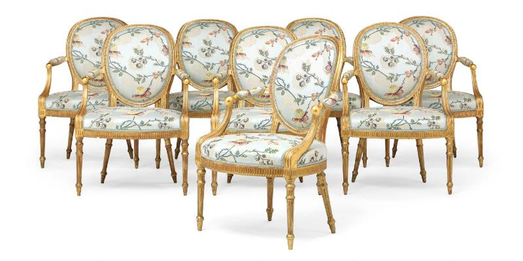An exceptional set of eight George III carved giltwood armchairs.
