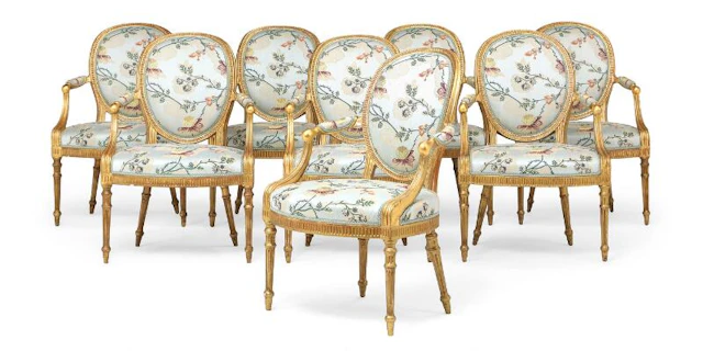 An exceptional set of eight George III carved giltwood armchairs.