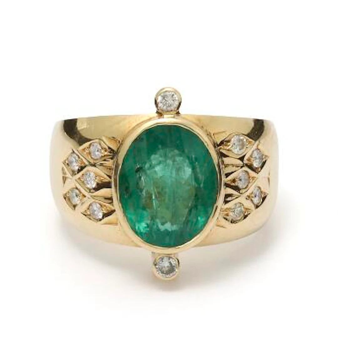 An emerald and diamond ring set with an emerald and diamond, mounted