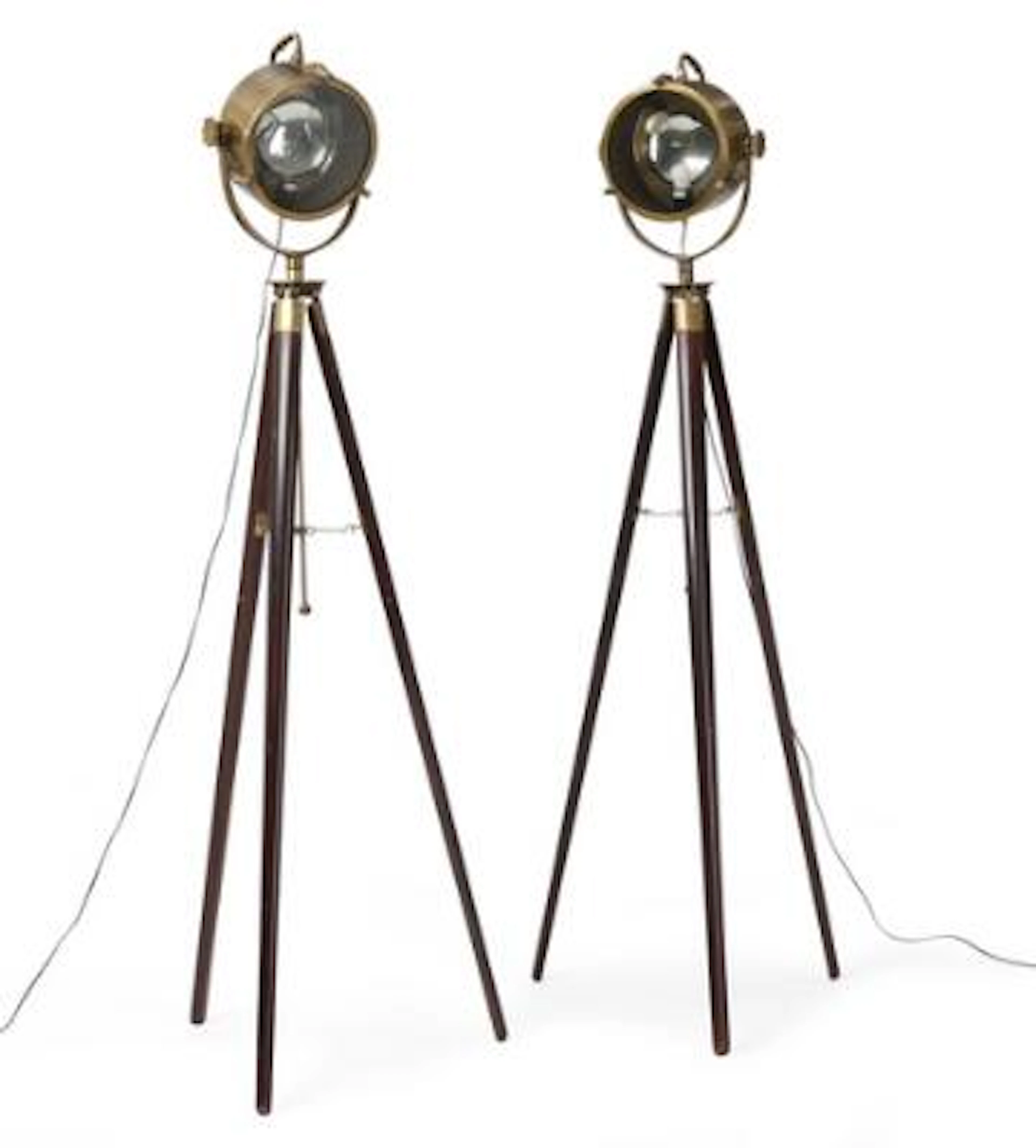 A pair of projector lamps in brass on tripod bases of dark-polished