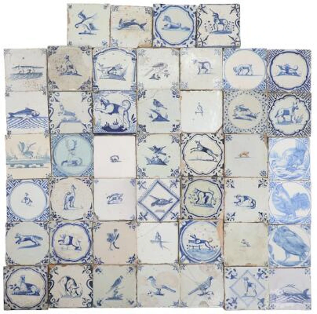 A collection of Dutch faience tiles, decorated in blue with animals