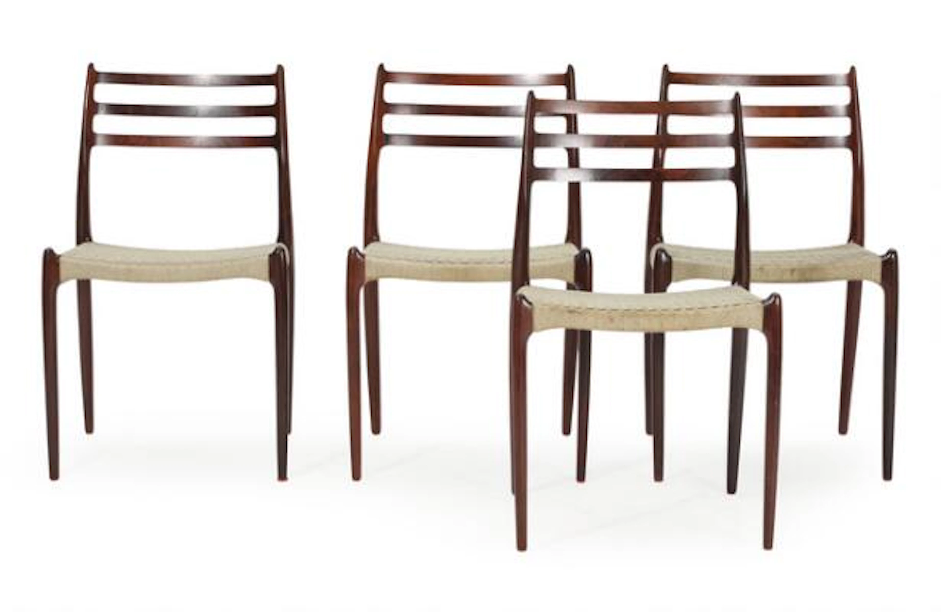 Niels O. Møller: Four rosewood chairs, seats woven with blue cord.