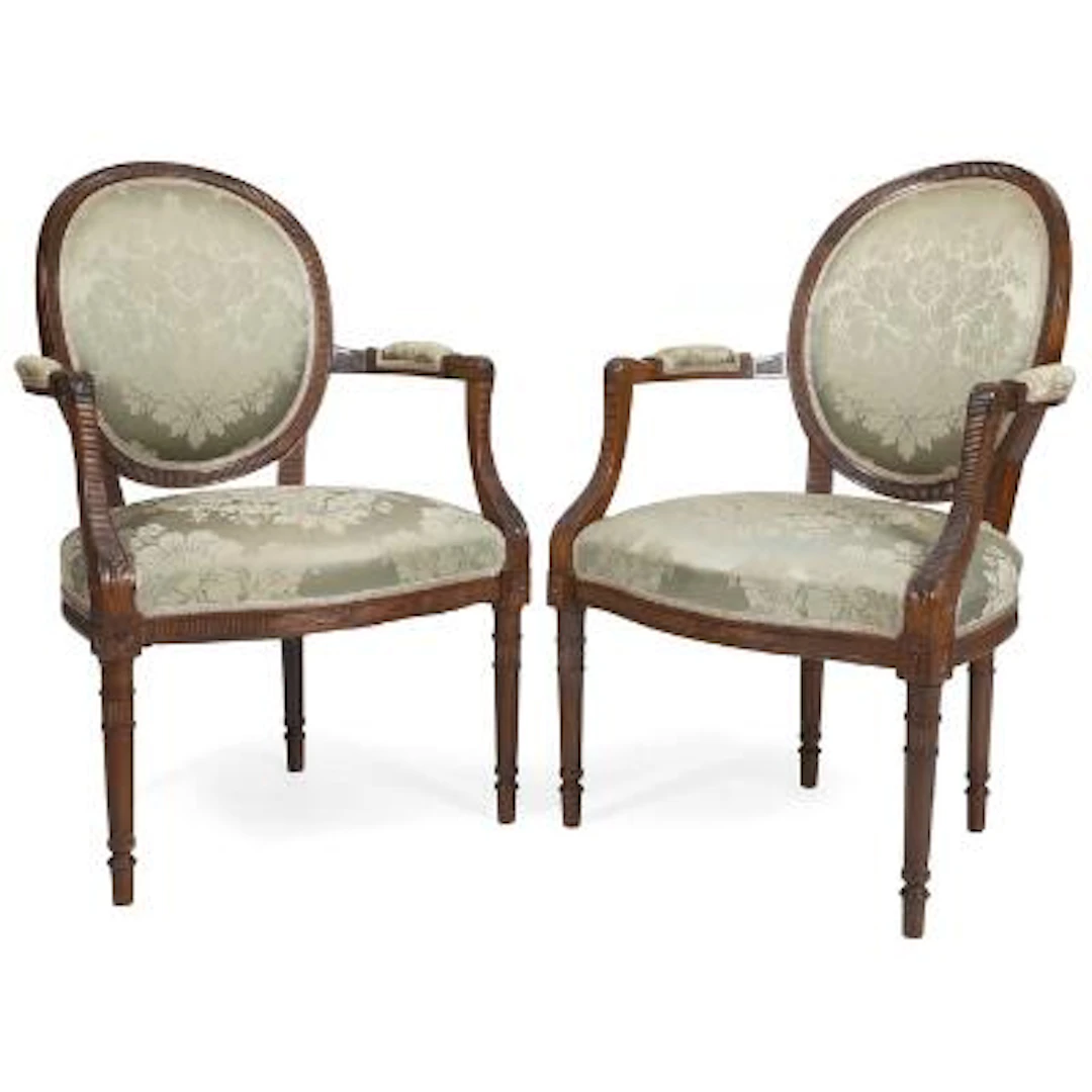 A pair of 20th century Loius XVI style walnut armchairs. Made for