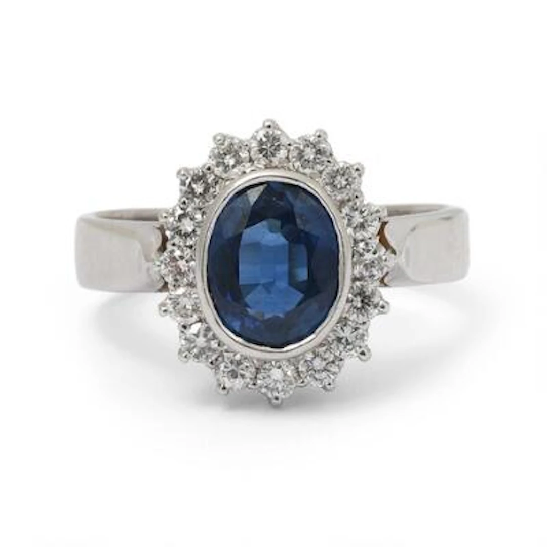 A sapphire and diamond ring set with a sapphire encircled by diamonds