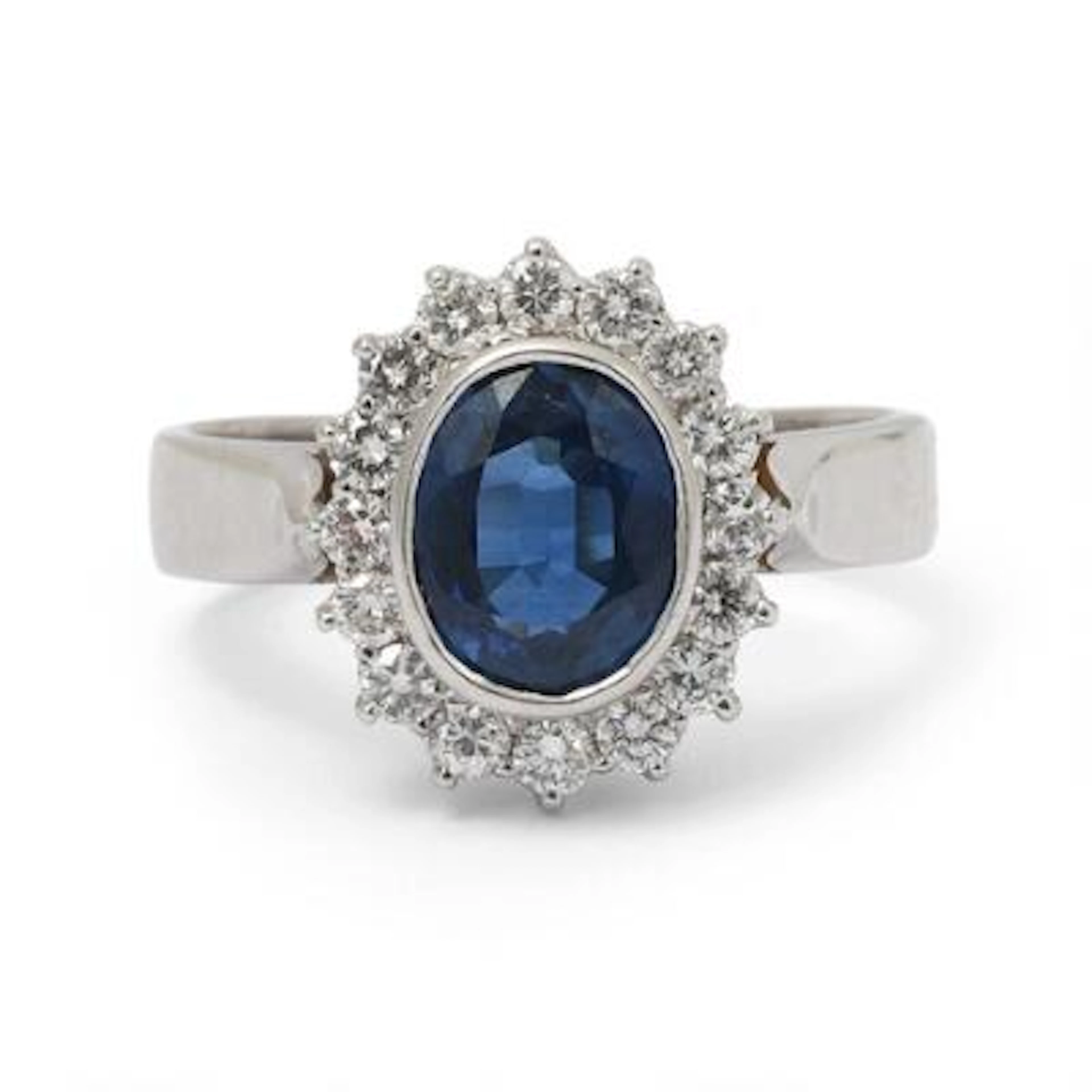 A sapphire and diamond ring set with a sapphire encircled by diamonds