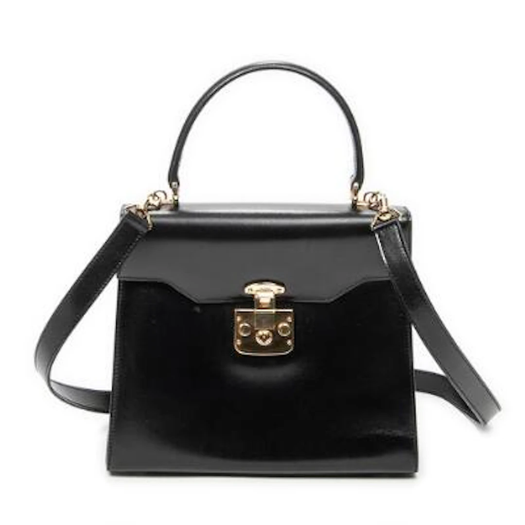 Gucci: A "Vintage Flap Top Handle" bag in black leather with gold-tone