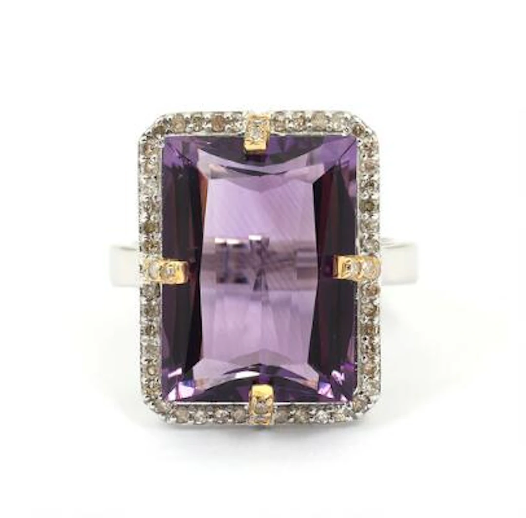 A topaz ring set with a faceted topaz and numerous diamonds, mounted