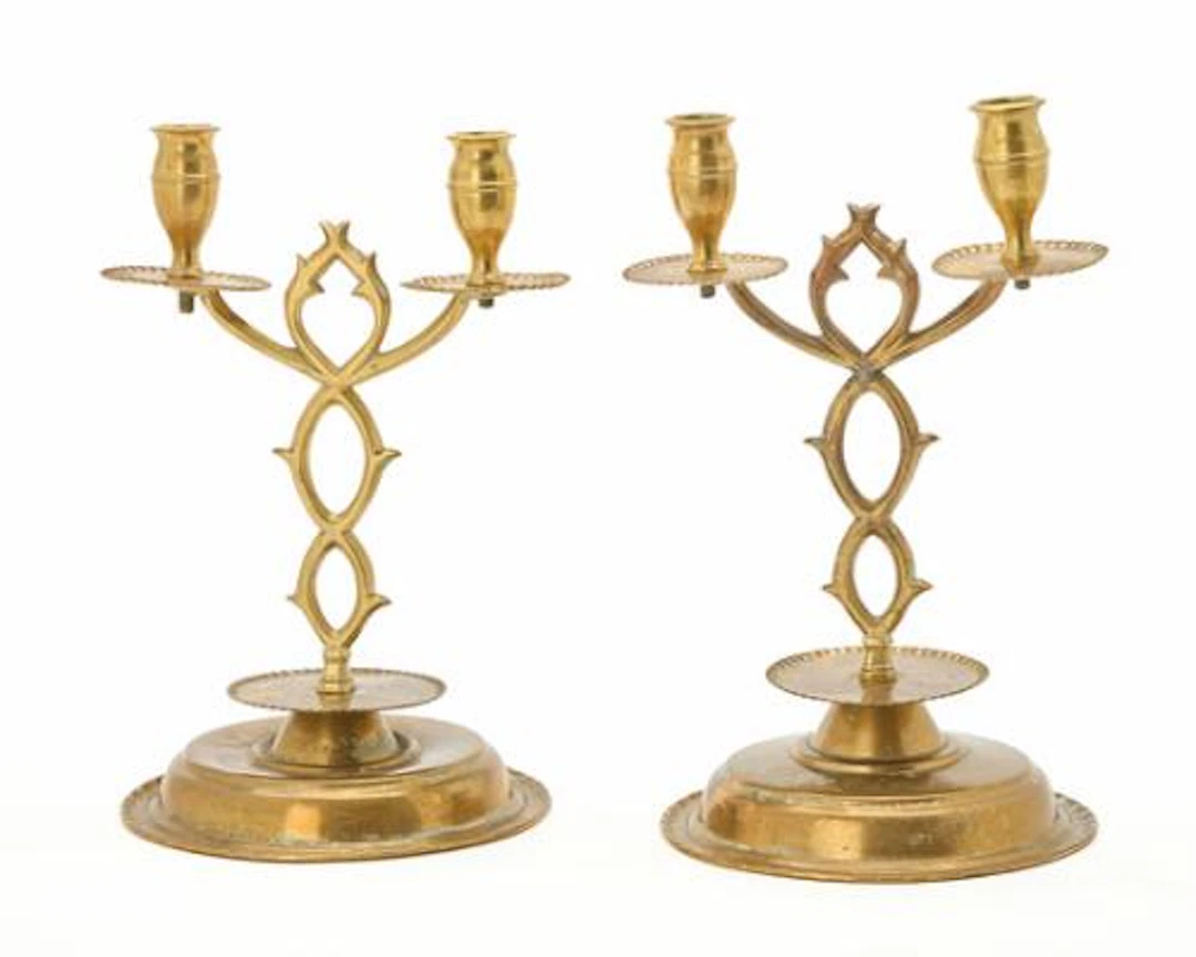 A pair of Swedish brass candlesticks with two light arms set on a