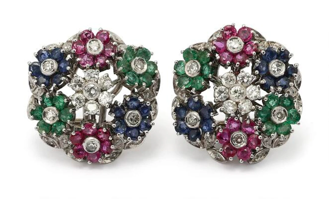 A pair of ear clips set with numerous diamonds, rubies, sapphires