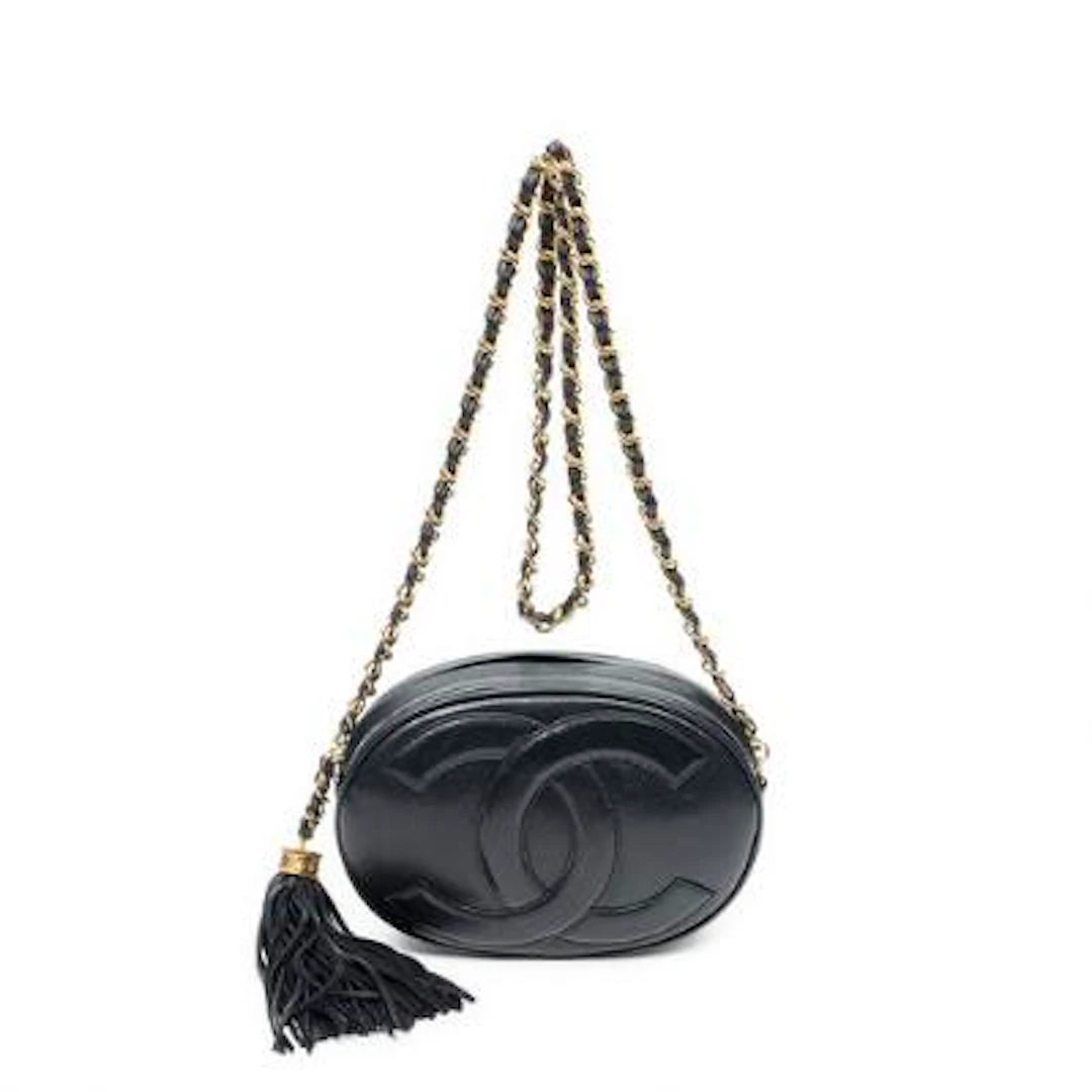 Chanel: A "CC Oval Tassel Camera Crossbody" bag of leather with gold