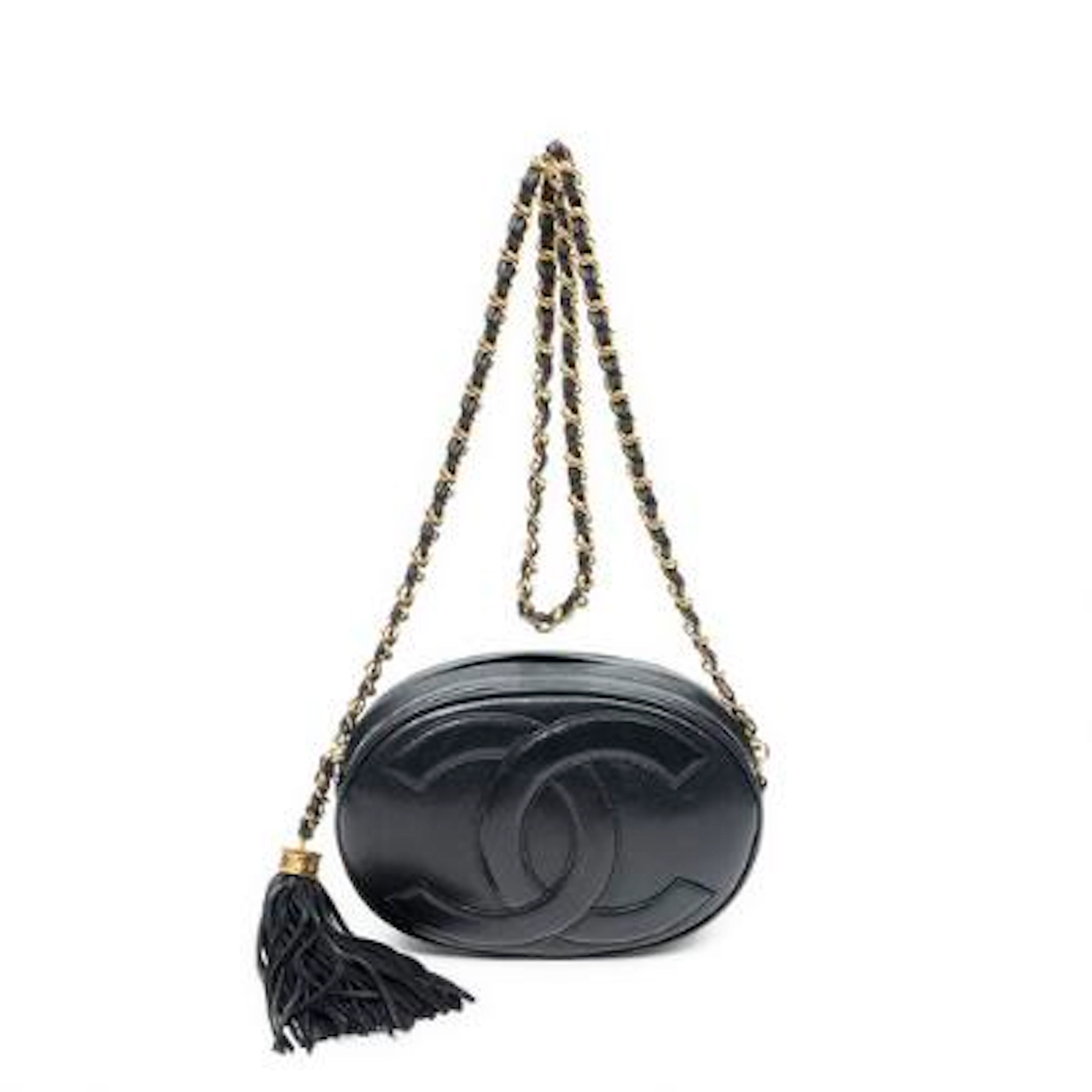 Chanel: A "CC Oval Tassel Camera Crossbody" bag of leather with gold