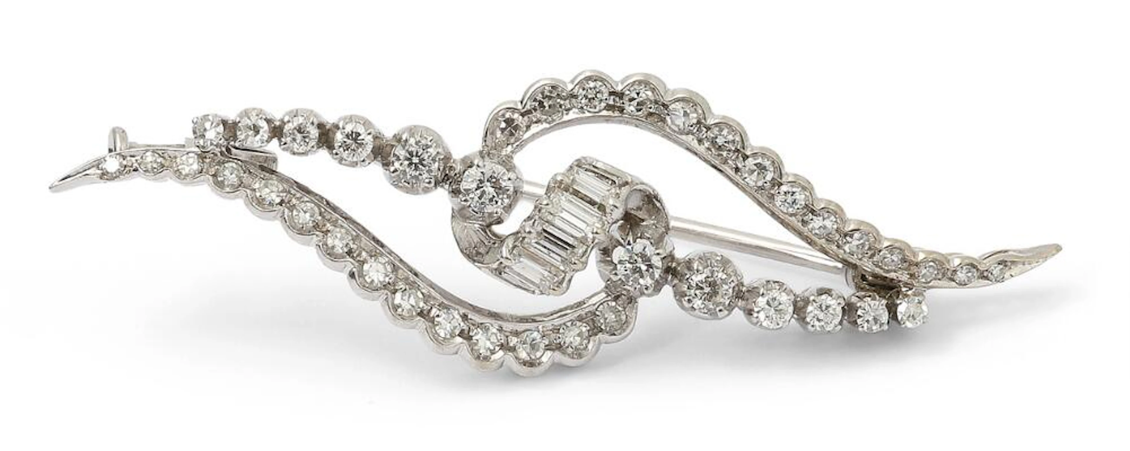 A diamond brooch set with numerous diamonds mounted in 18k white gold.
