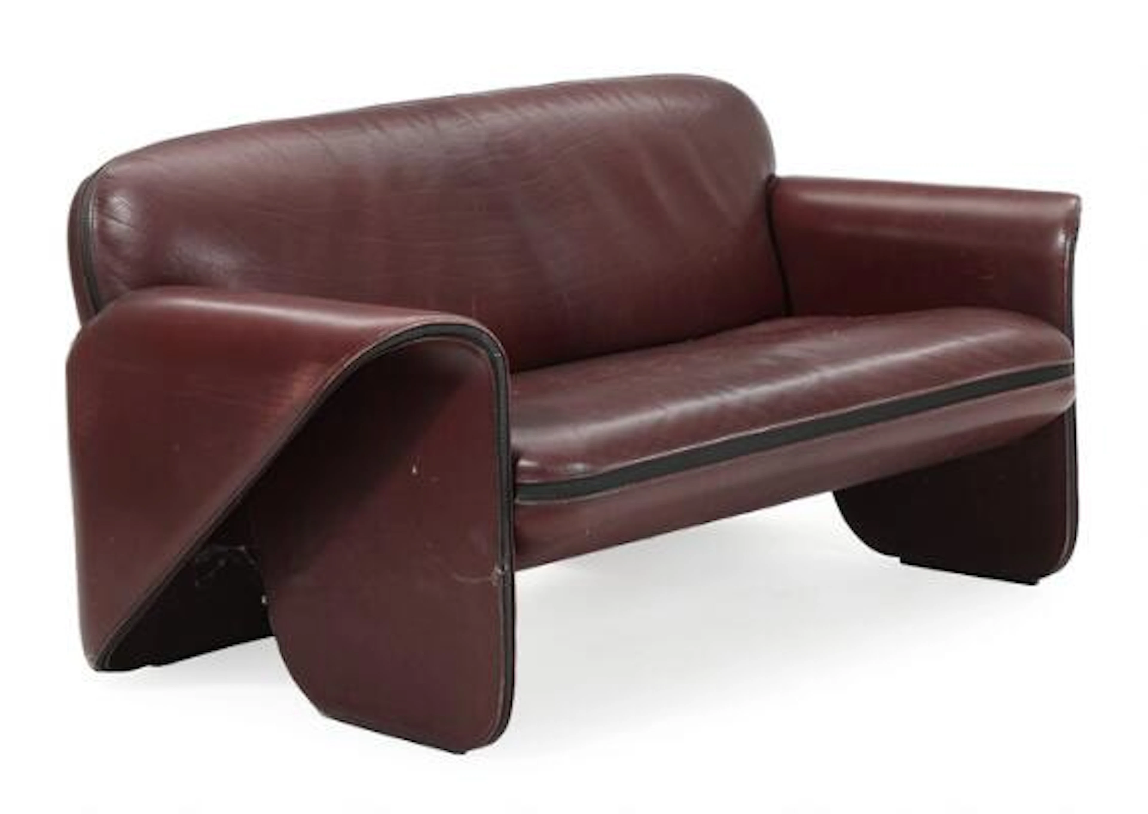 Gerd Lange: Two seater sofa upholstered with claret coloured leather.