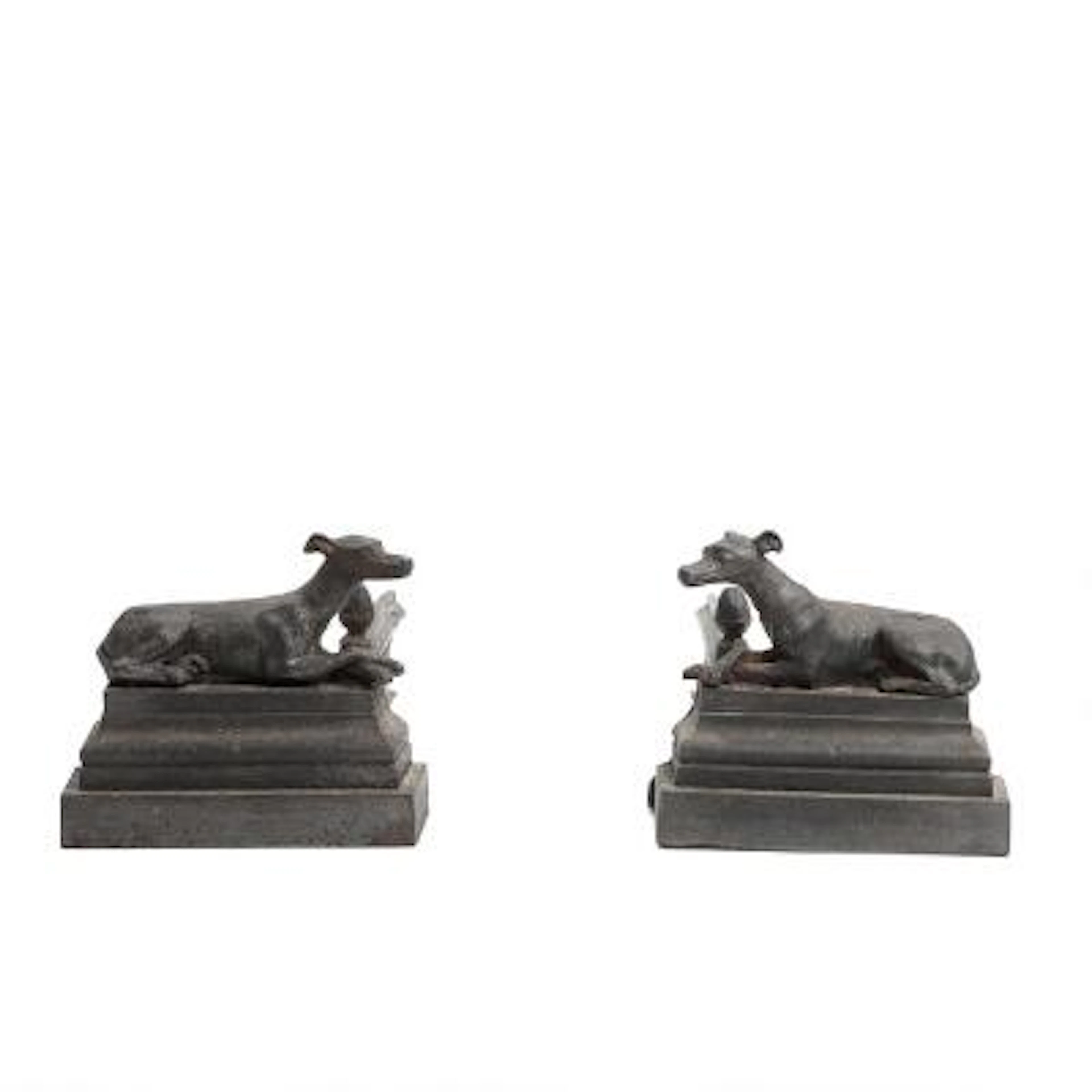 A pair of fireplace firedogs of black-painted cast iron, cast with