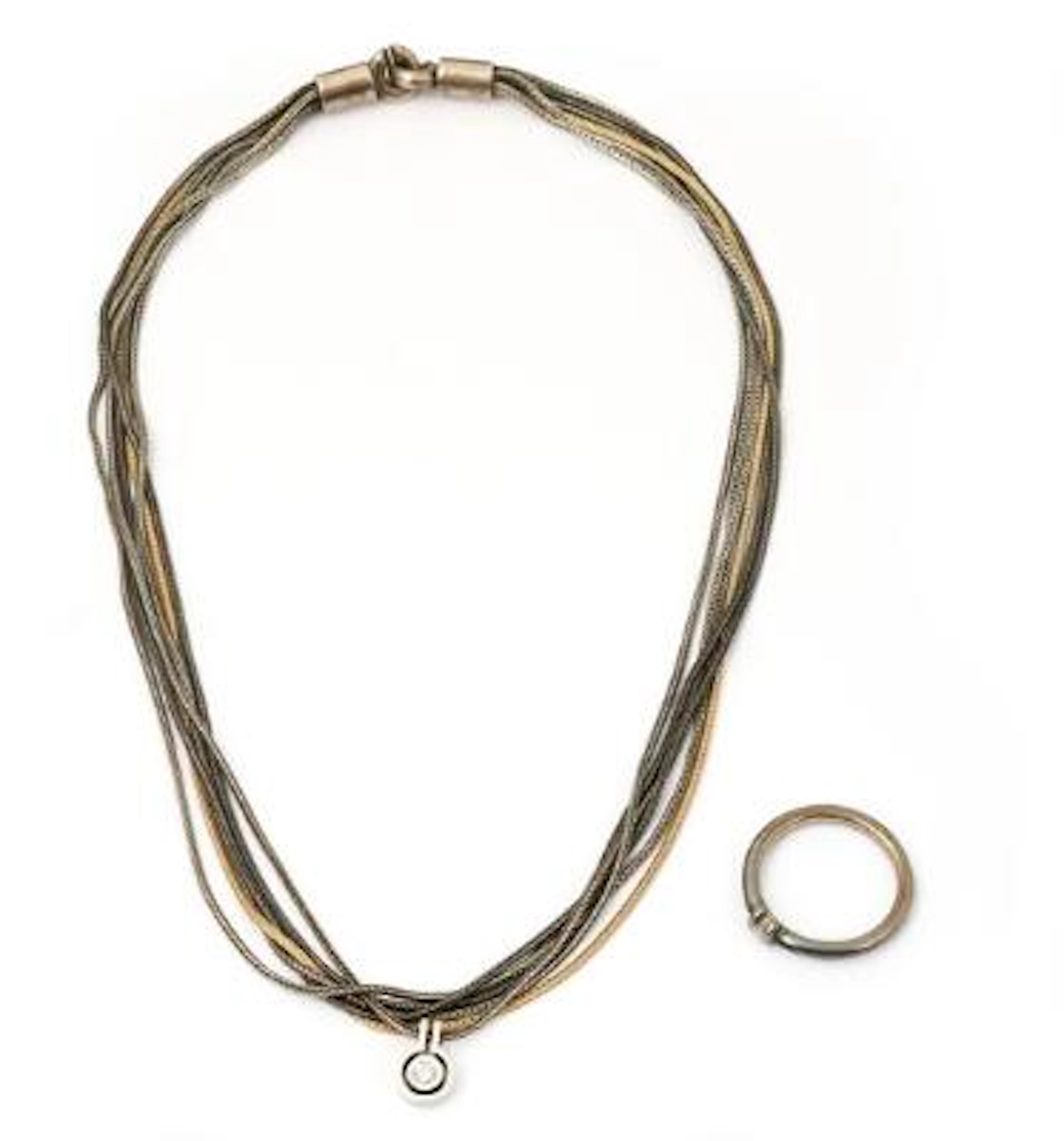A necklace of 14k gold and oxidised silver set with a diamond pendant