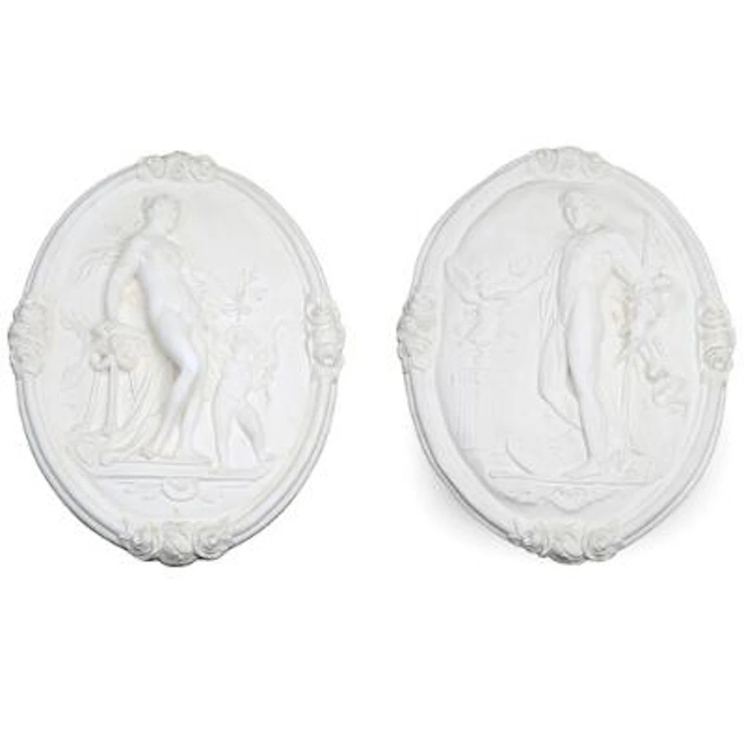 Two oval white-painted plaster plaques decorated with Apollo and Venus