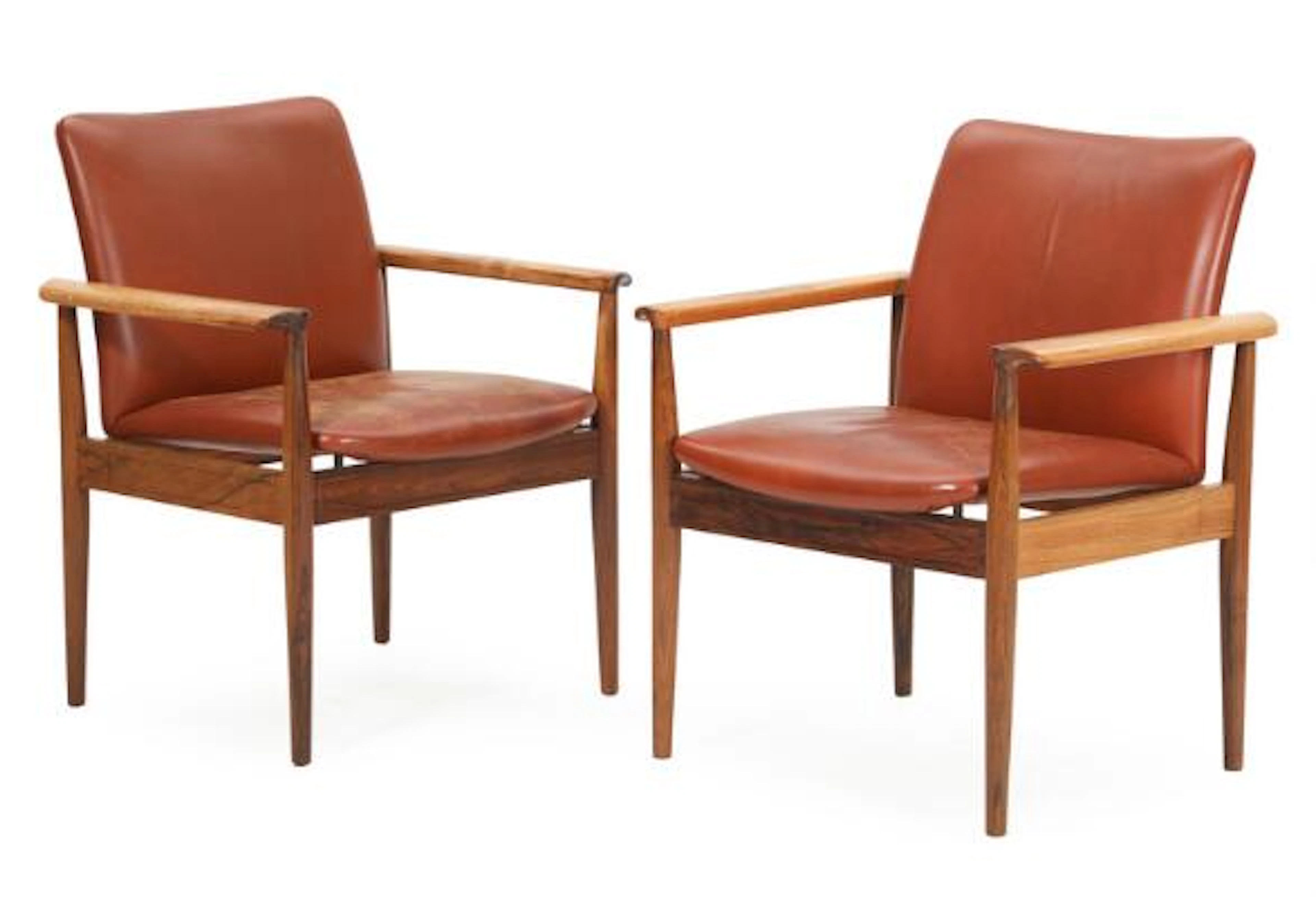 Finn Juhl: "Diplomat". A pair of rosewood armchairs with brown leather.
