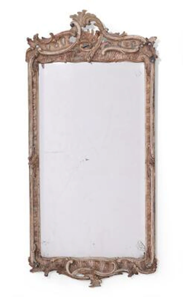 A German Rococo mirror in frame of painted wood, presumably formerly