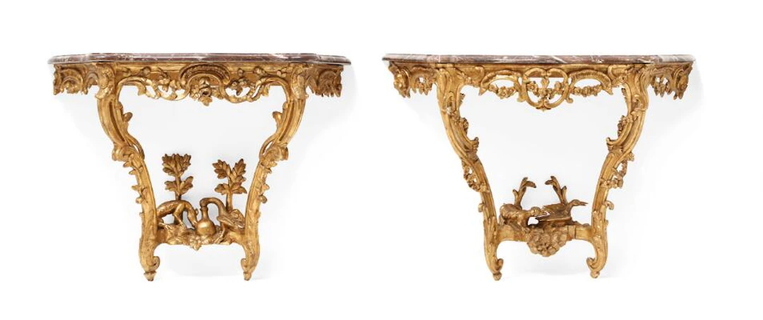 A pair of nearly identical Louis XV consoles with scenes from Aesop's