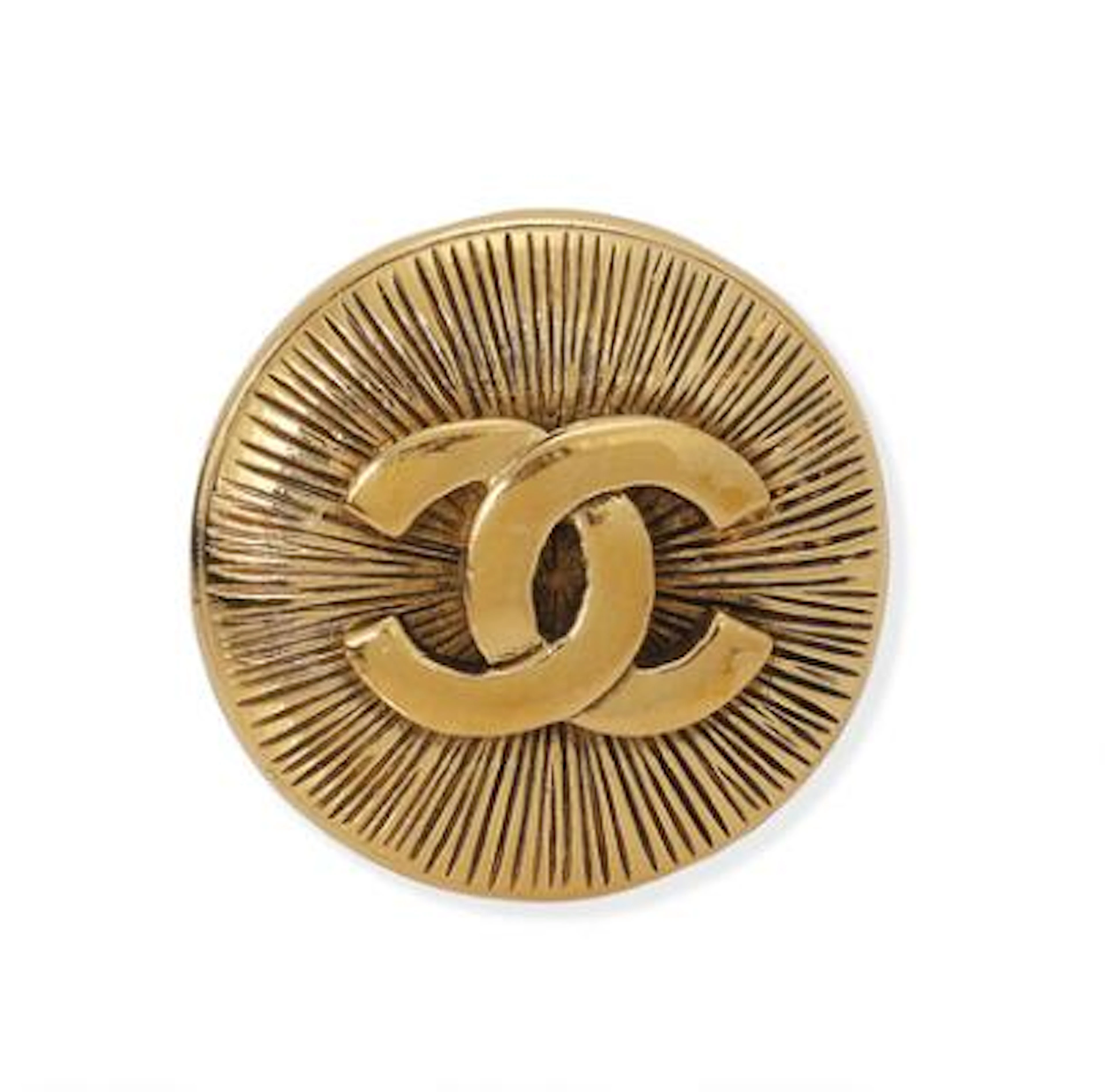 Chanel: A brooch set with a CC logo on the front, mounted in gold