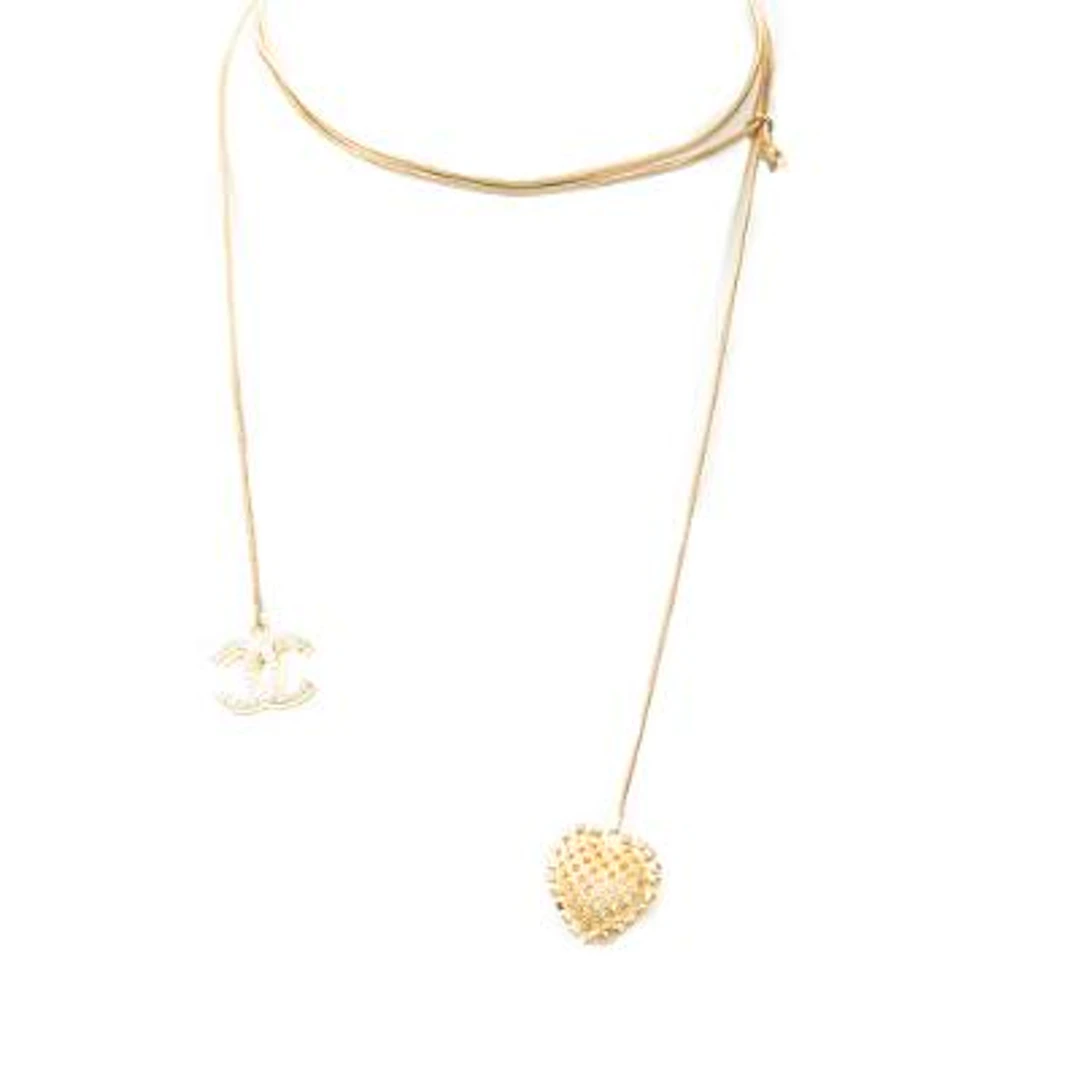 Chanel: A necklace of gold-toned metal set with a CC pendant and a