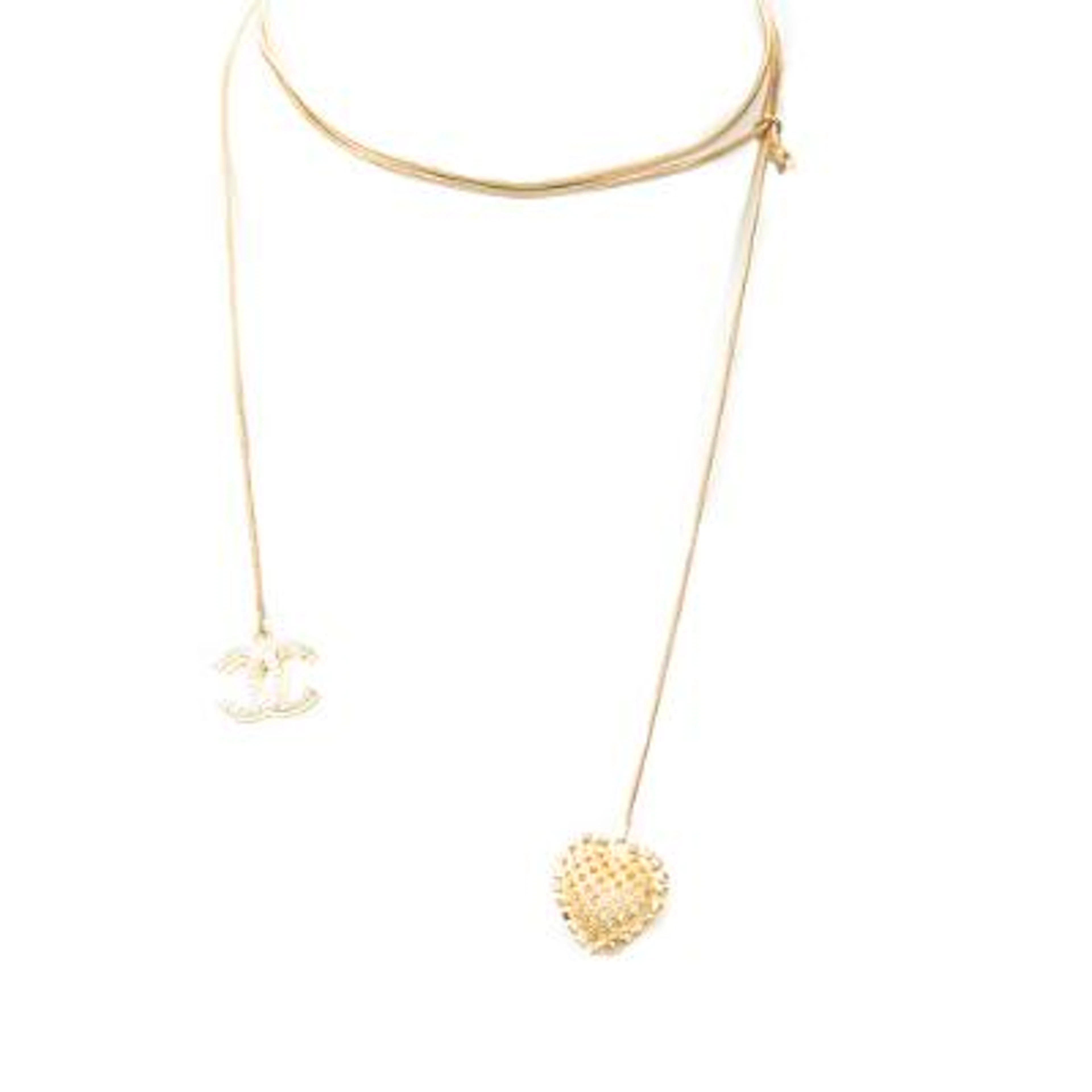 Chanel: A necklace of gold-toned metal set with a CC pendant and a