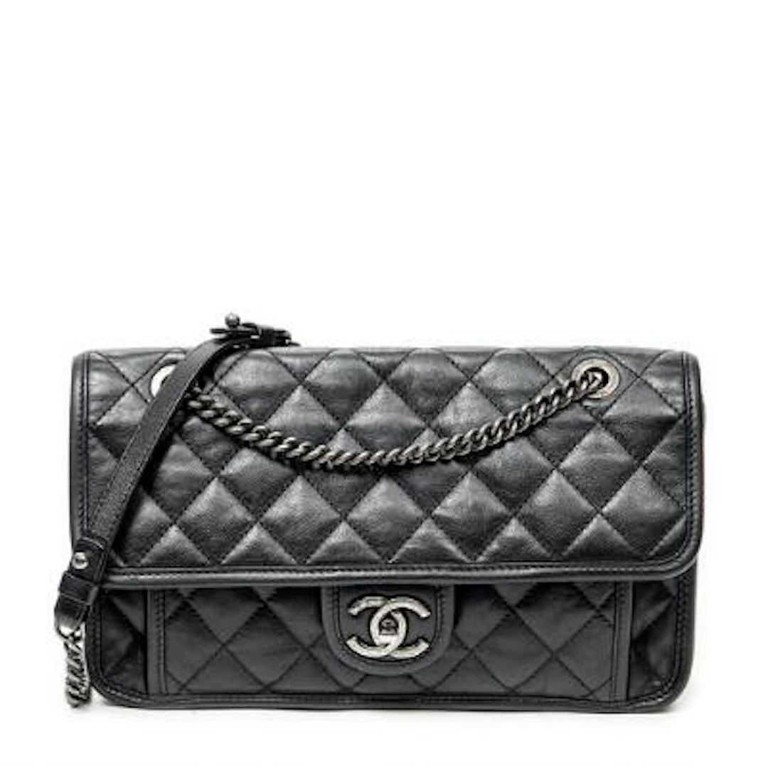 Chanel: A "French Riviera Flap" bag of black leather with silver-toned