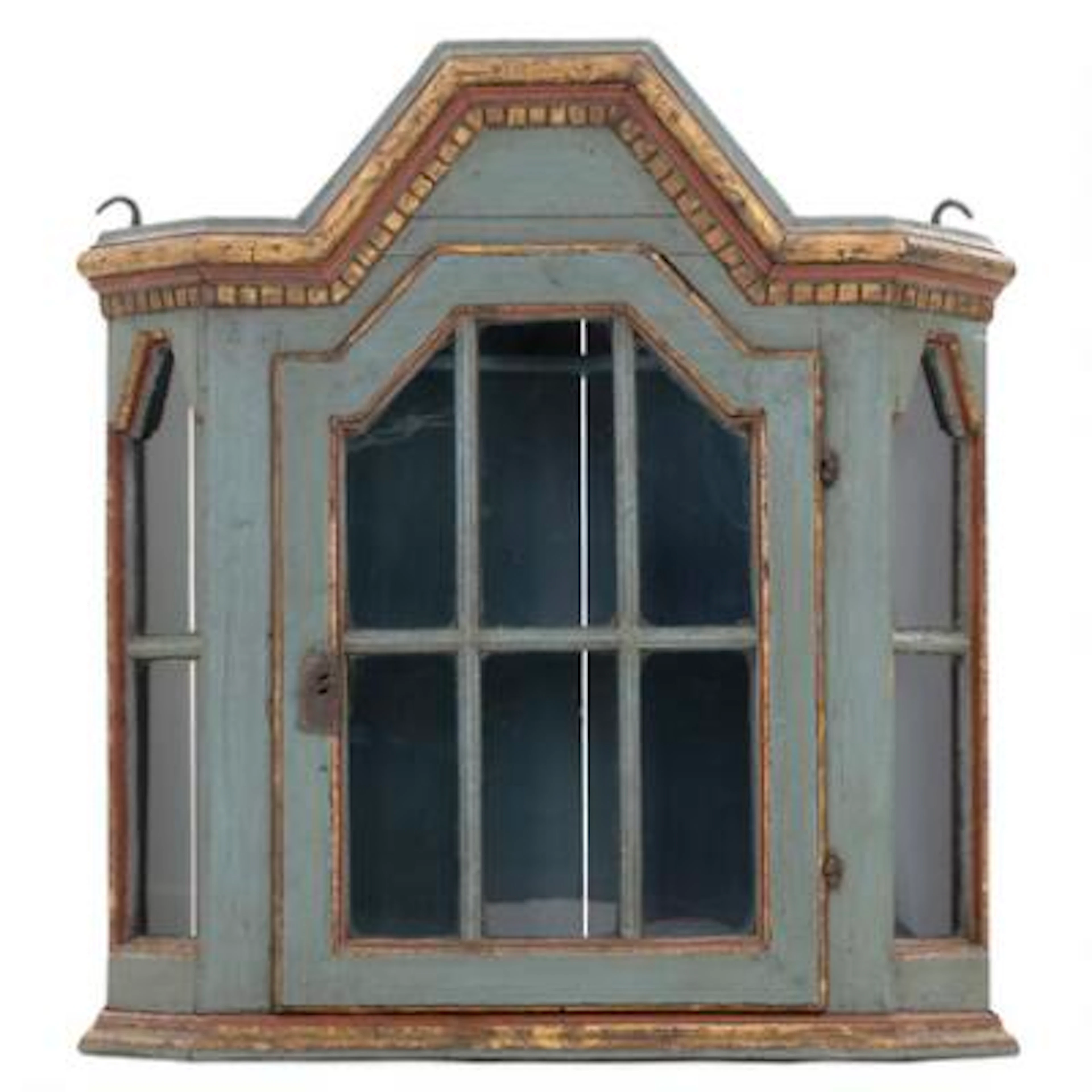 A small rual wall cabinet of painted wood, front with glass panes.