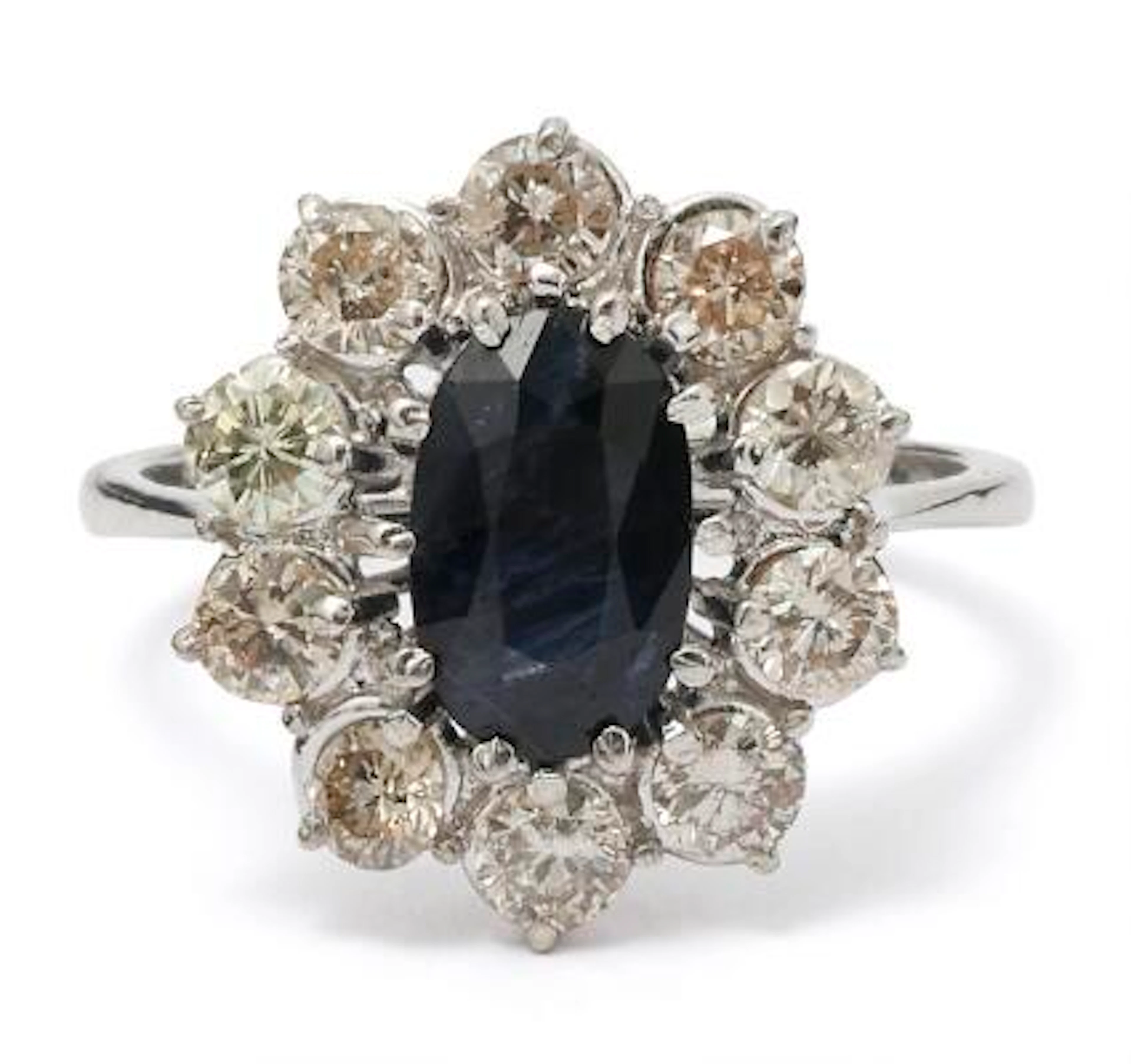 A sapphire and diamond ring set with a sapphire encircled by numerous