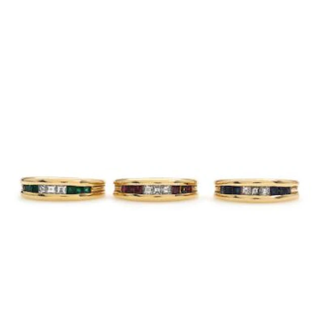 Bucherer: A ruby and diamond ring, an emerald and diamond ring and