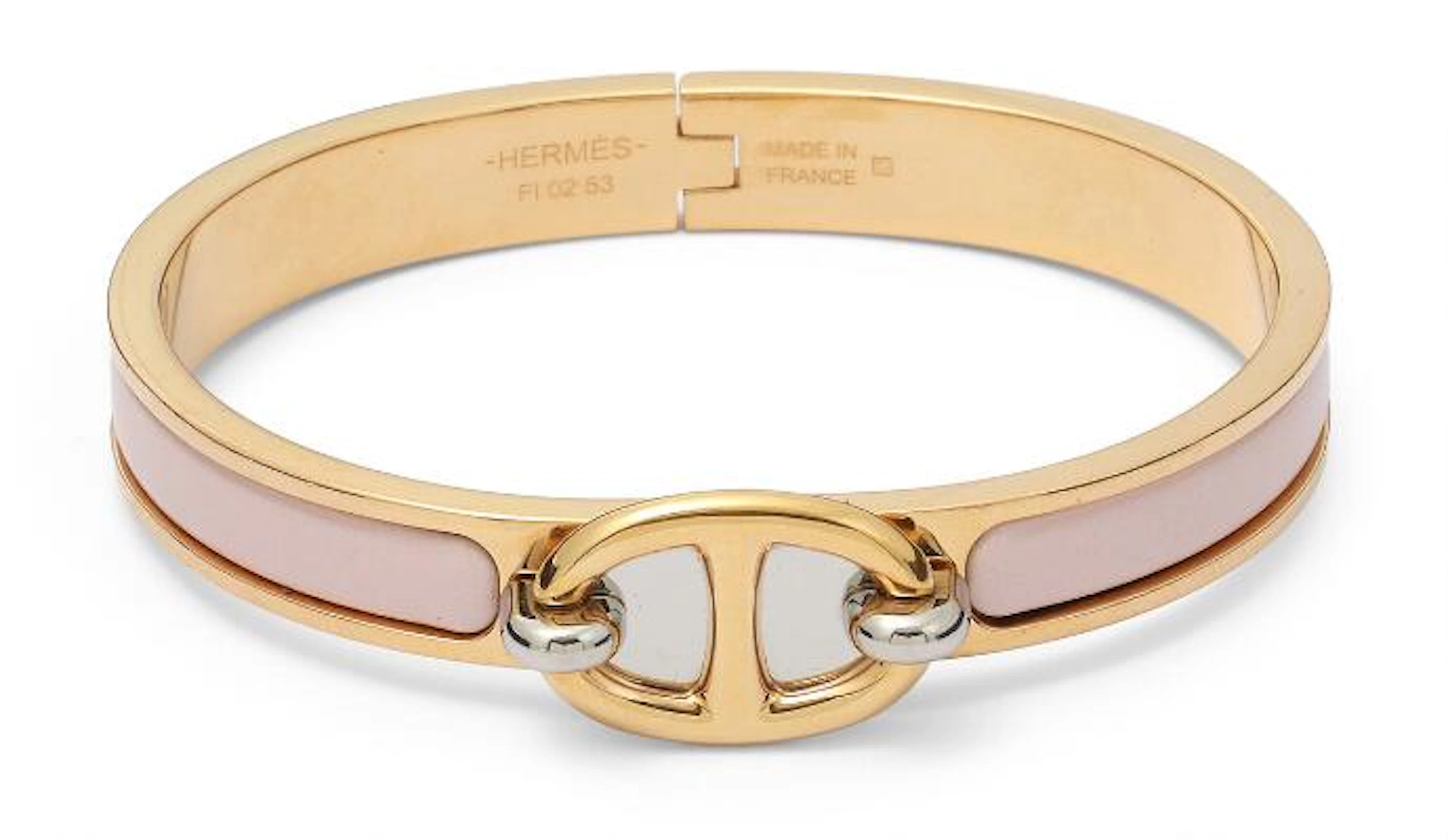 Hermès: A "Mini Clic Chaine d'Ancre" bangle of gold and silver tone