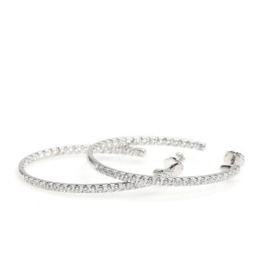 A pair of diamond ear hoops set with numerous brilliant-cut diamonds