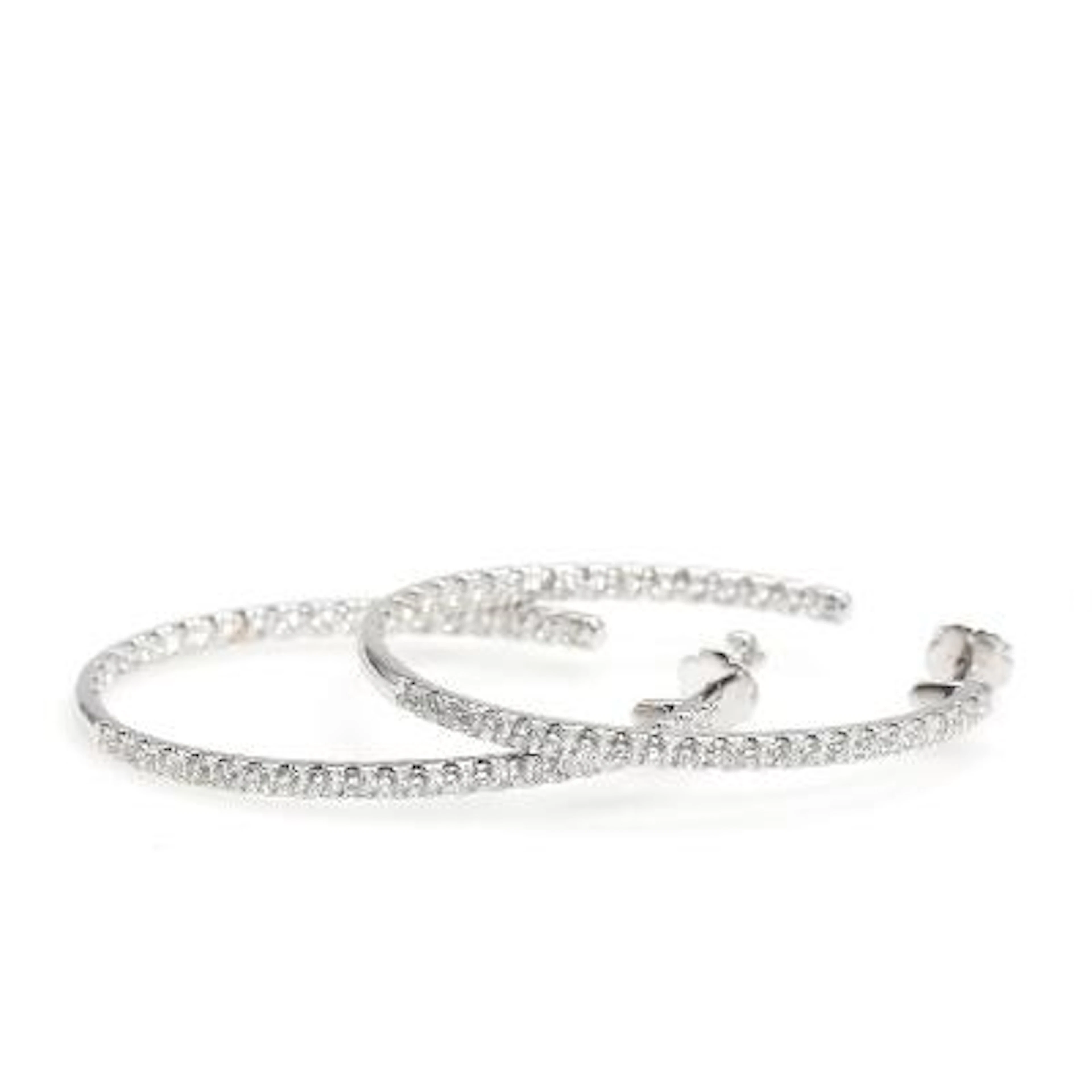 A pair of diamond ear hoops set with numerous brilliant-cut diamonds