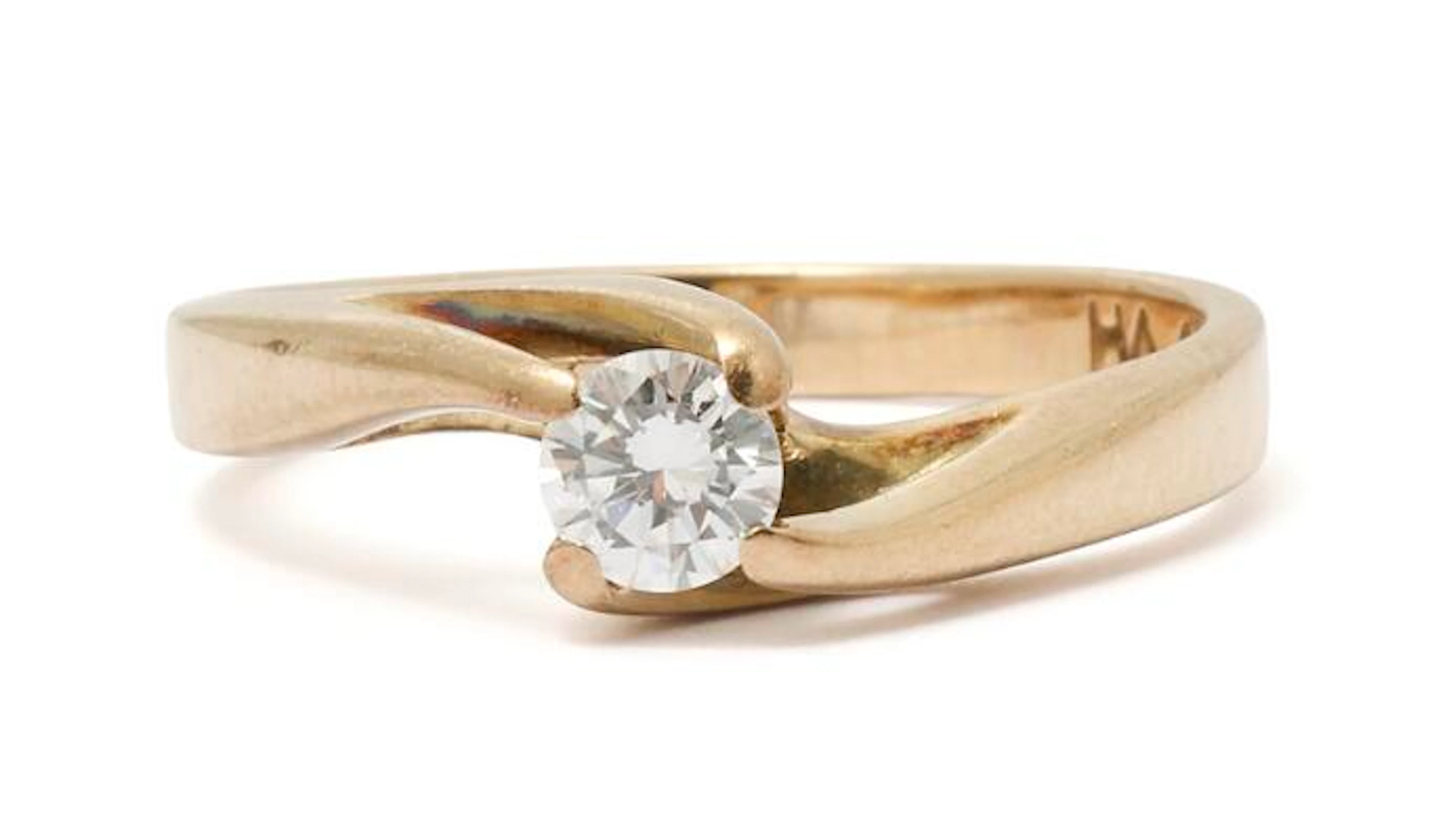 A diamond ring set with a brilliant-cut diamond weighing app. 0.24