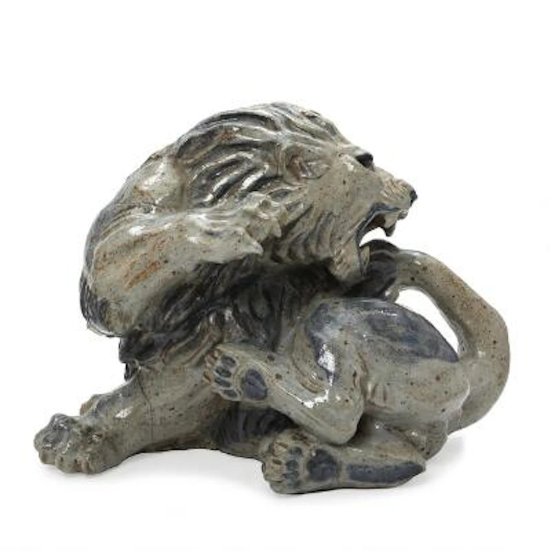 Knud Kyhn: A reclining, roaring stoneware lion. Signed monogram KK