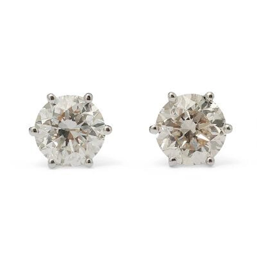 A pair of solitaire diamond ear studs each set with a brilliant-cut