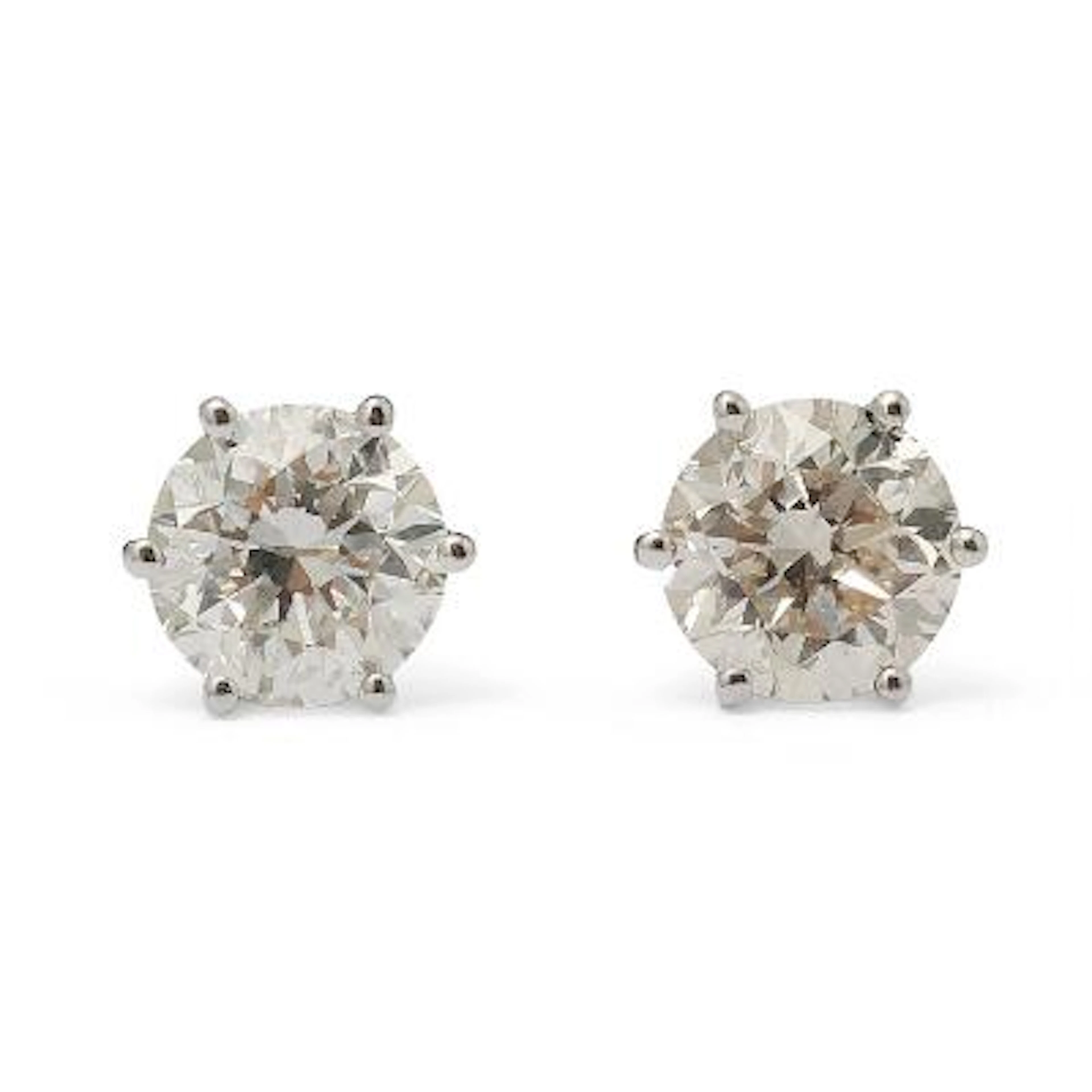 A pair of solitaire diamond ear studs each set with a brilliant-cut