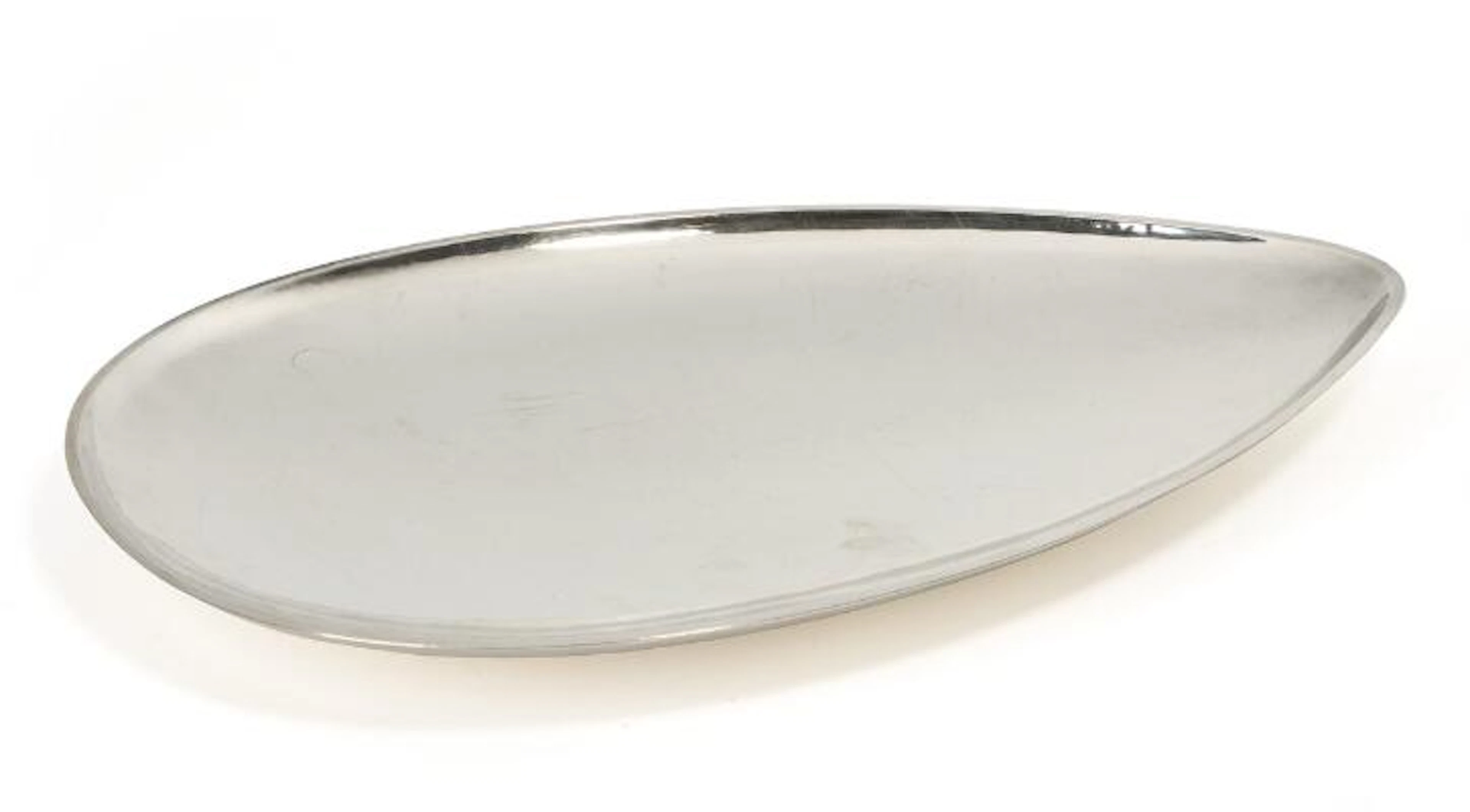 C.C. Hermann: A large, drop-shaped silver dish with hammered surface.